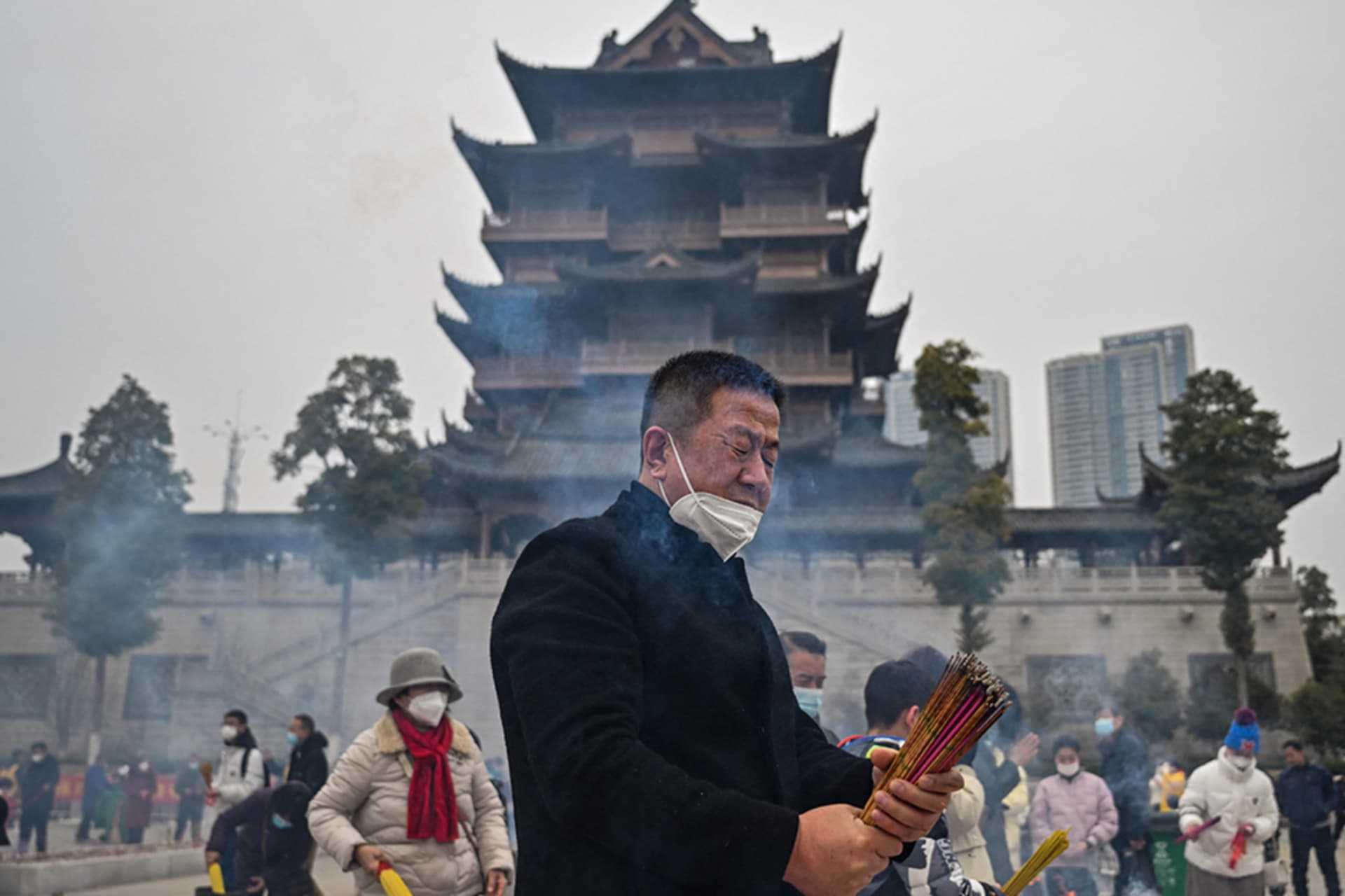 <p>People burn incense at the Buddhist Guiyuan Temple in Wuhan, China.</p>
