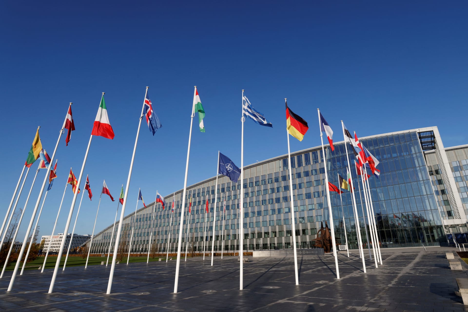 <p>Flags fly outside NATO’s headquarters in Brussels, Belgium, on November 16, 2022.</p>
