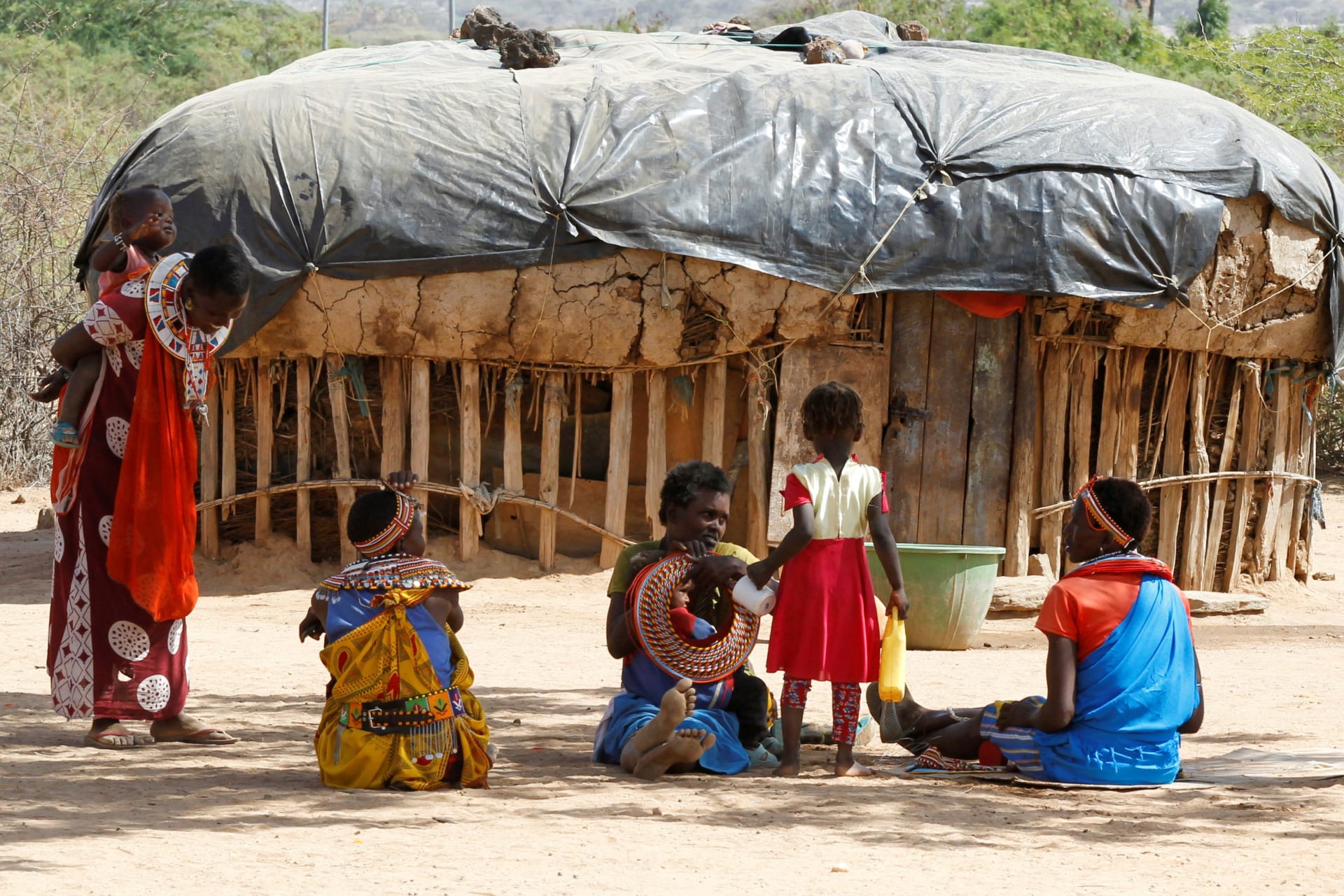 <p>Women from the Samburu tribe who escaped from gender based violence play with their children outside a traditional mud dwelling known as Manyatta at the Umoja village where men are restricted, in Samburu near Archers Post in the northern Samburu County, K</p>
