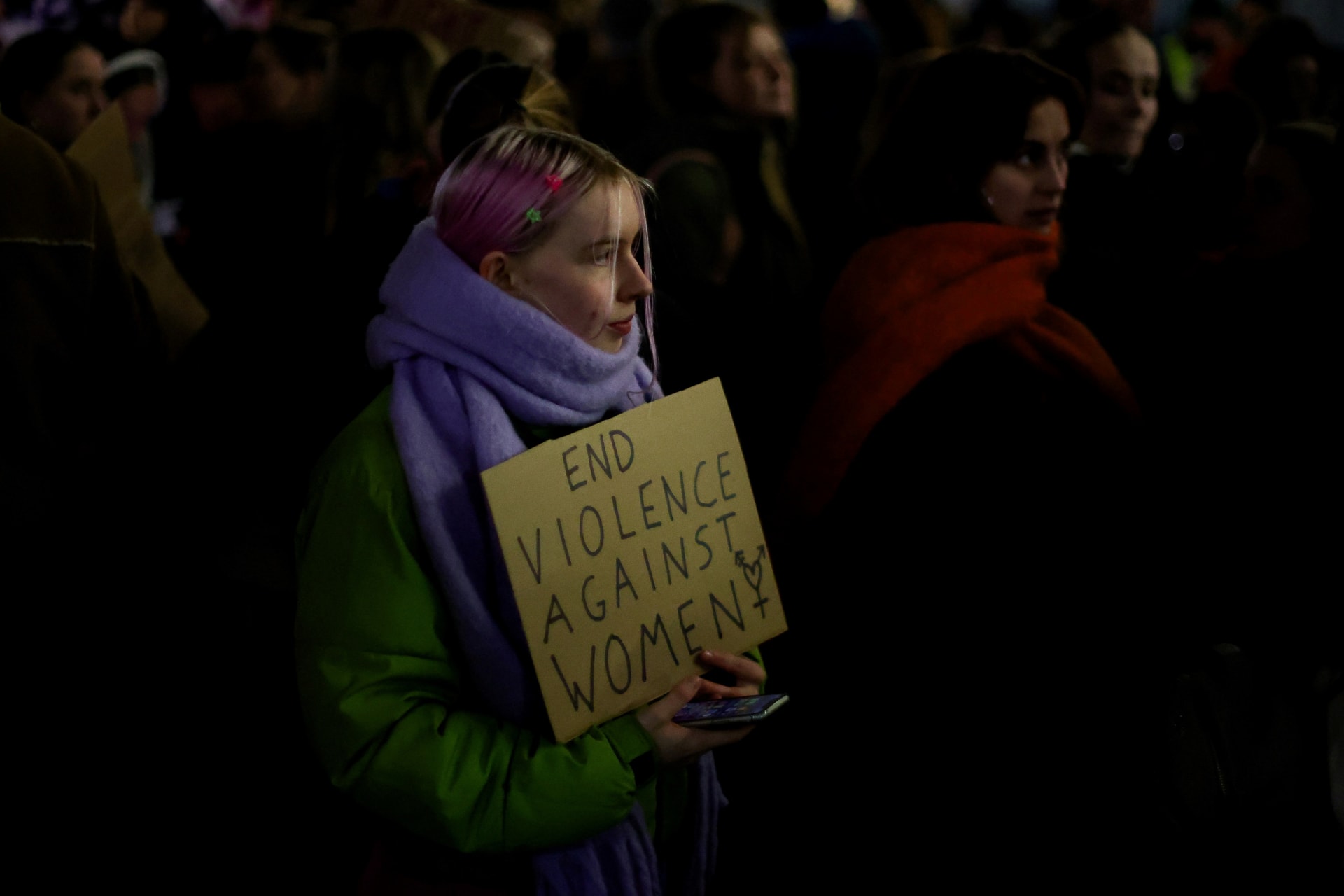 <p>A woman holds a placard as people gather to demonstrate during the Reclaim the Night march to stop gender based violence, in Manchester, Britain, November 29, 2023. </p>
