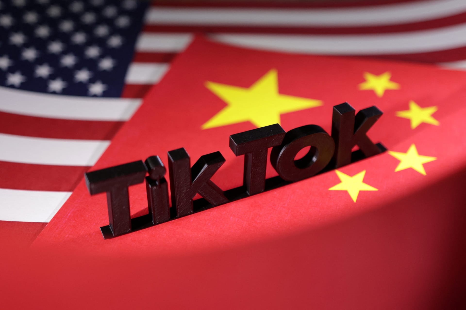 <p>TikTok logo is placed on the U.S. and Chinese flags in this illustration.</p>
