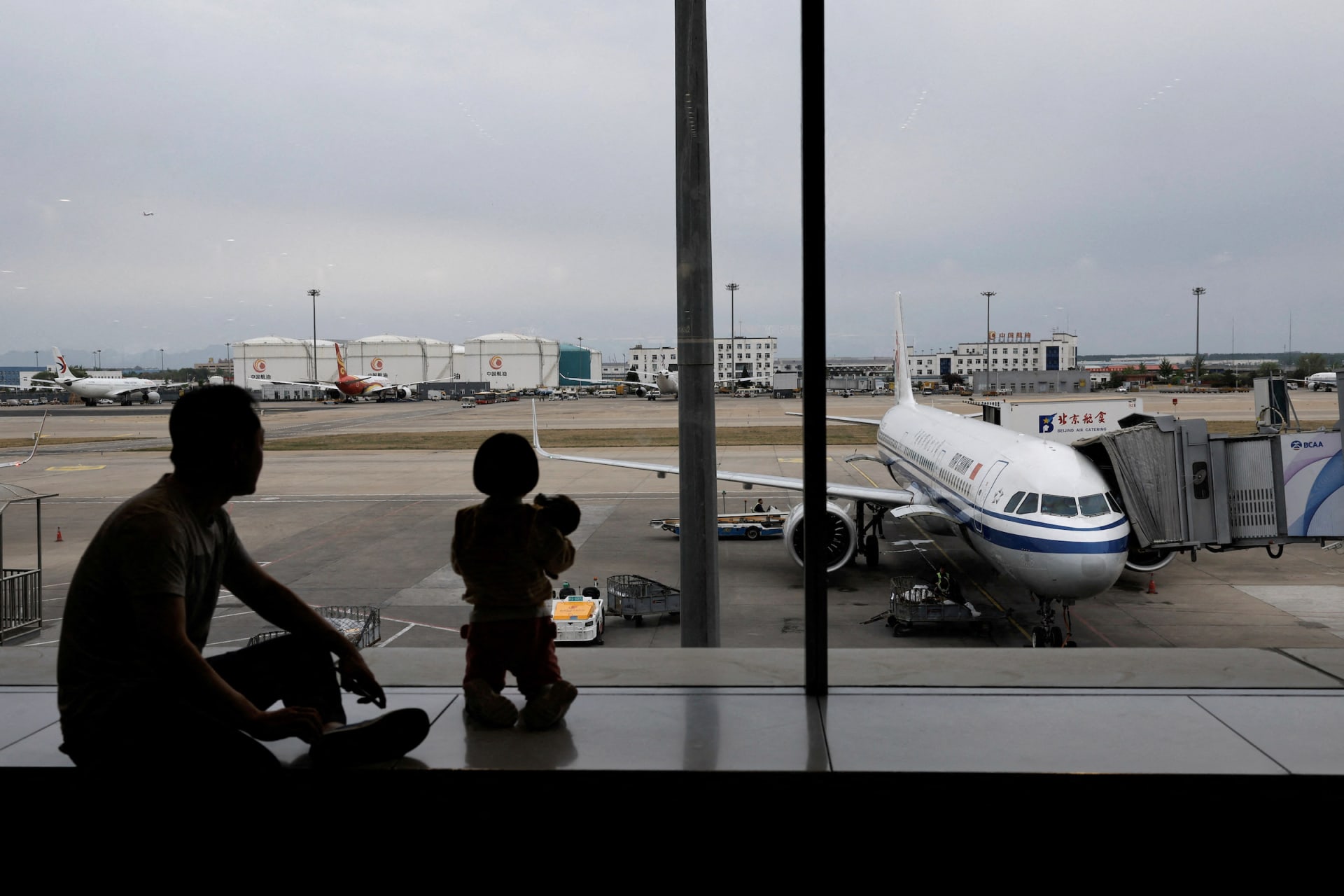 <p>Passengers await boarding for flights at Beijing Capital International Airport in Beijing, China.</p>
