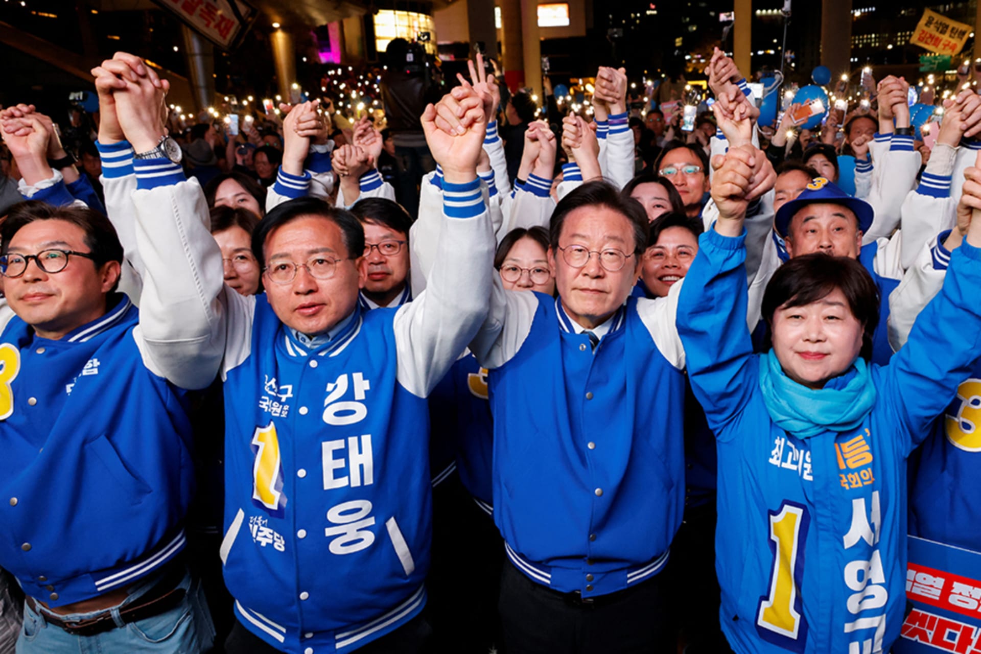 <p>Lee Jae-myung (middle), leader of the main opposition Democratic Party, stands with supporters at a campaign rally in Seoul, South Korea on April 9, 2024.</p>
