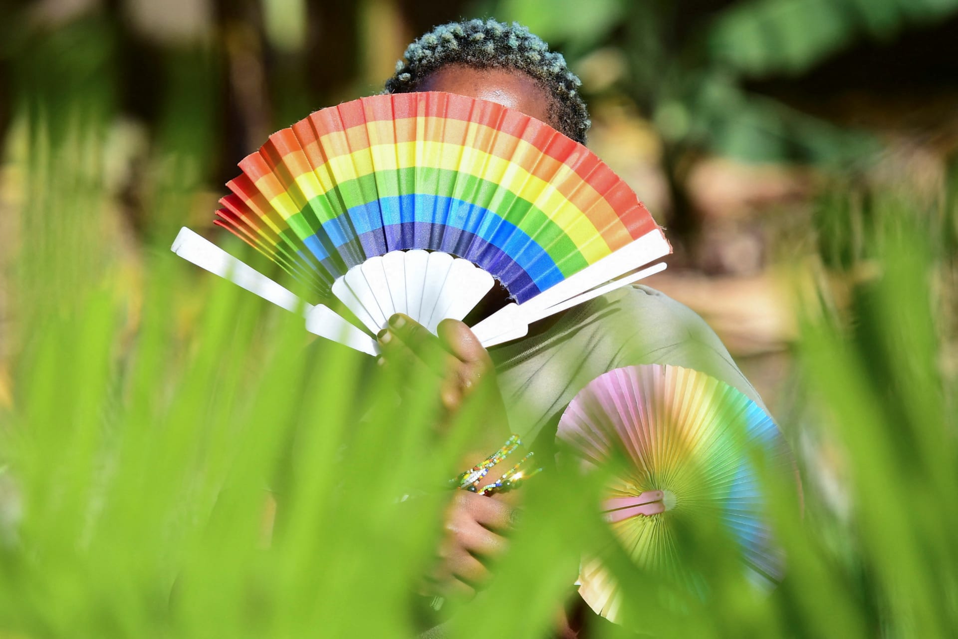 <p>A member of the LGBTQ+ community poses for a picture with rainbow colors at the offices of Rella Women’s Empowerment Program for LGBTQ+ rights advocacy in Uganda on April 4, 2023.</p>
