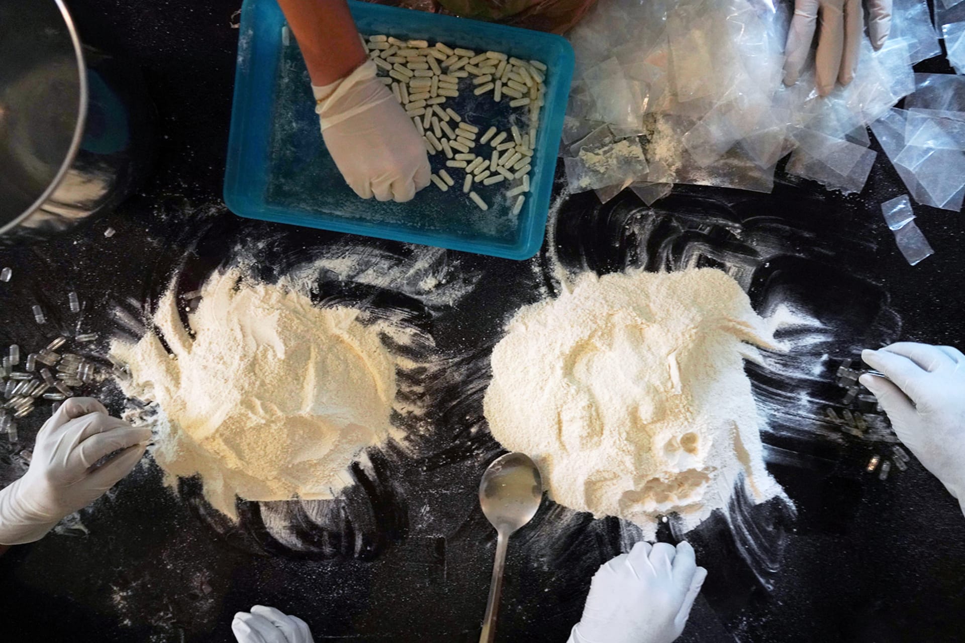 <p>Members of the Sinaloa Cartel prepare capsules with methamphetamine in a safe house in Culiacan, Mexico.</p>
