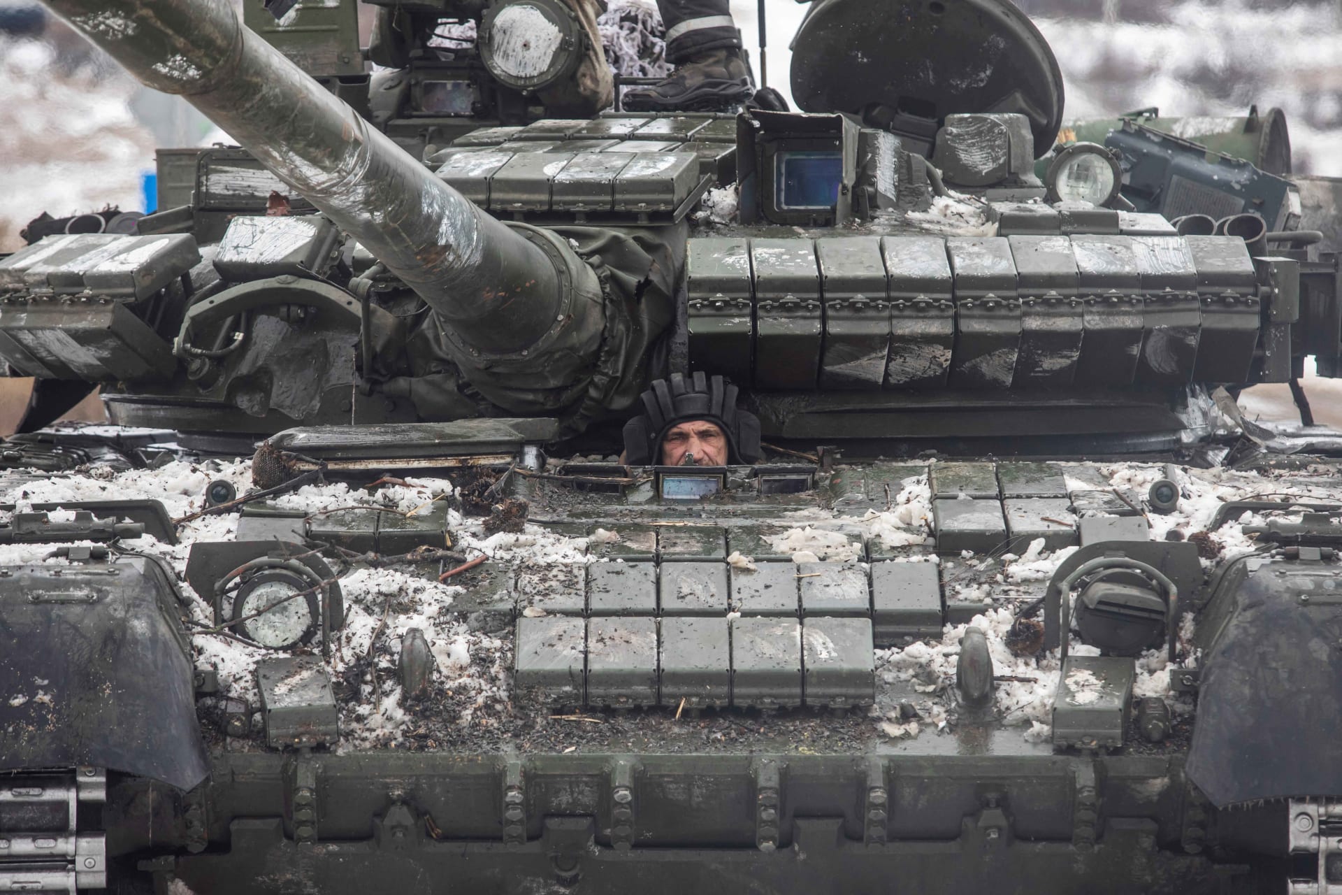 <p>A Ukrainian servicemember drives a tank in the Donetsk region on February 14, 2023.</p>
