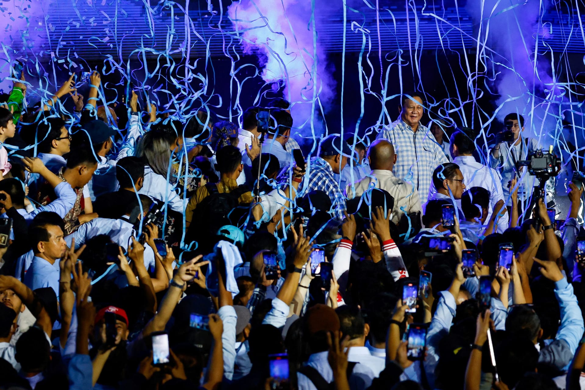 <p>Supporters gather around Presidential candidate Prabowo Subianto as he claims victory after unofficial vote counts during an event to watch the results of the general election in Jakarta, Indonesia, February 14, 2024. </p>
