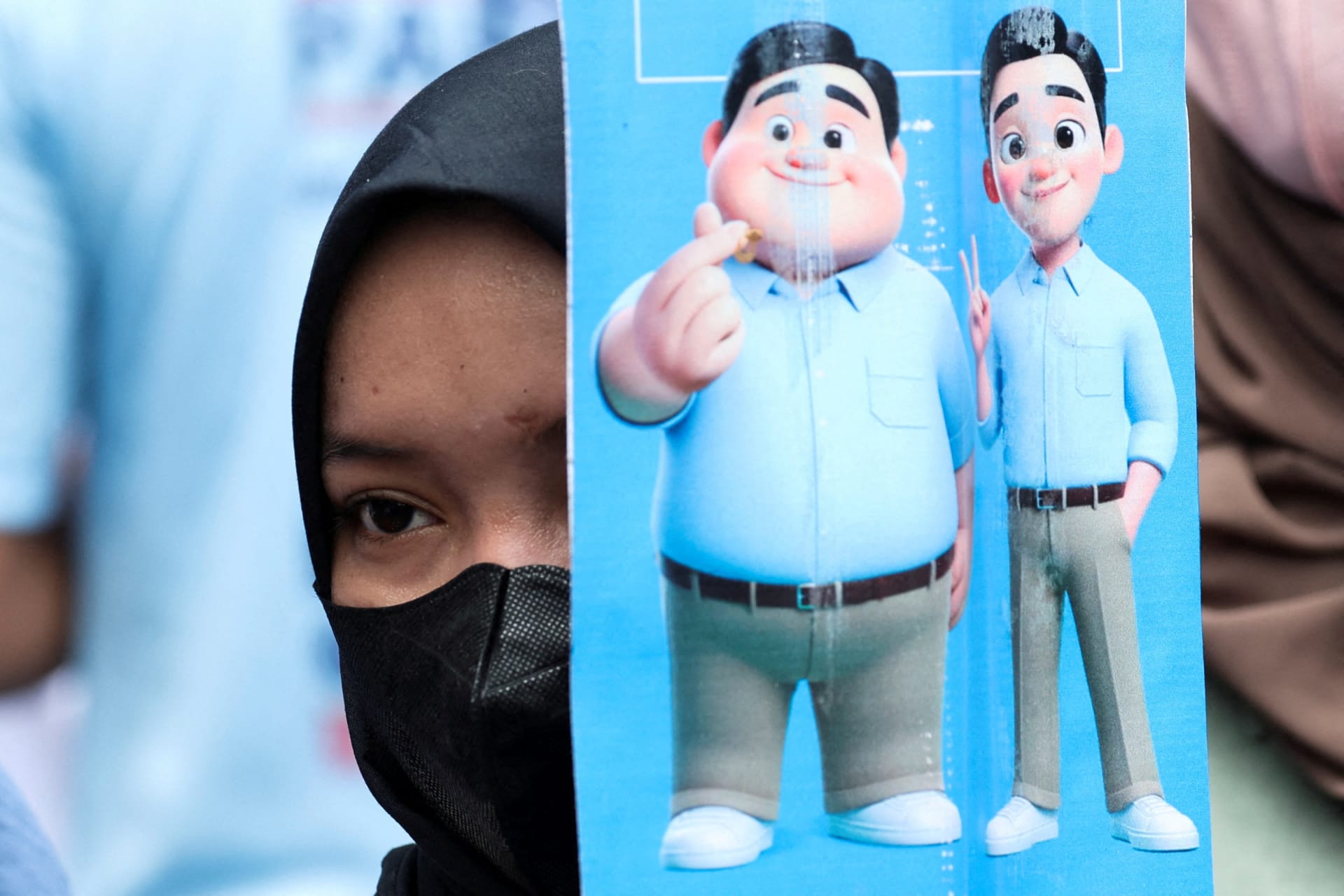 <p>A supporter holds a picture of a cartoon version of Indonesia’s Defence Minister and presidential candidate Prabowo Subianto and his running mate Gibran Rakabuming Raka, at their campaign rally in Jakarta, Indonesia on February 10, 2024.</p>
