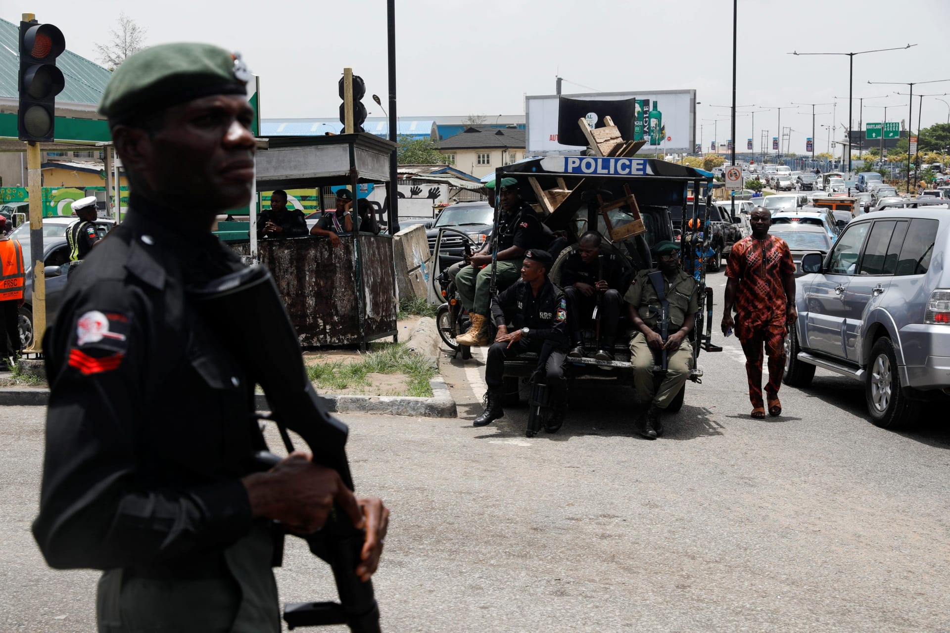 <p>A man walks past police officers in position, as protesters block the domestic terminal of Murtala Muhammed International Airport during a strike over working conditions and wages, in Lagos, Nigeria on April 17, 2023.</p>
