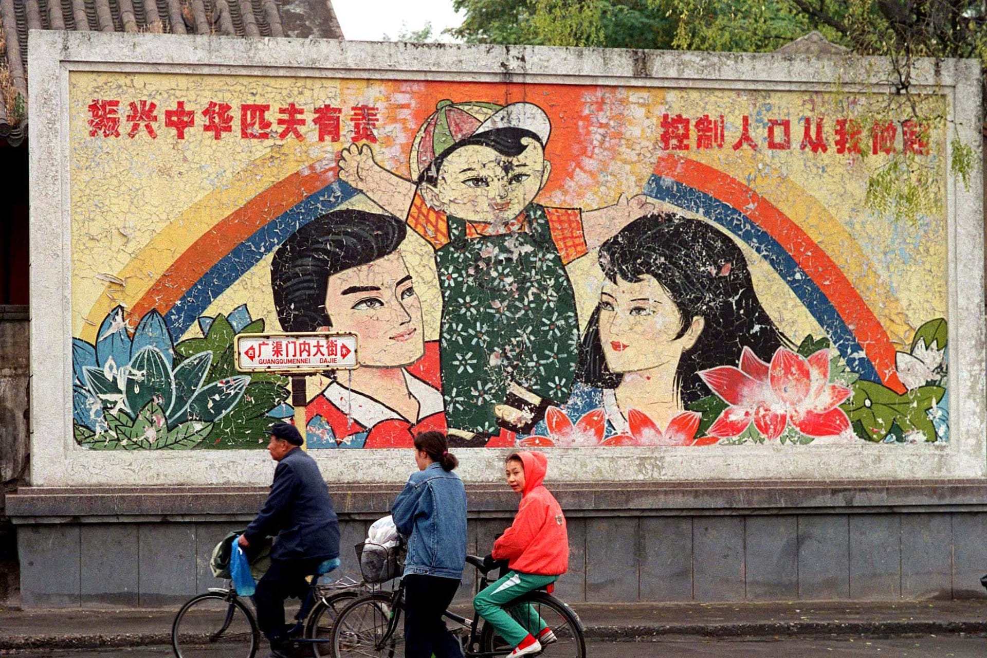 <p>A decaying mural promoting China’s one-child policy can be seen from a street in Beijing, China.</p>
