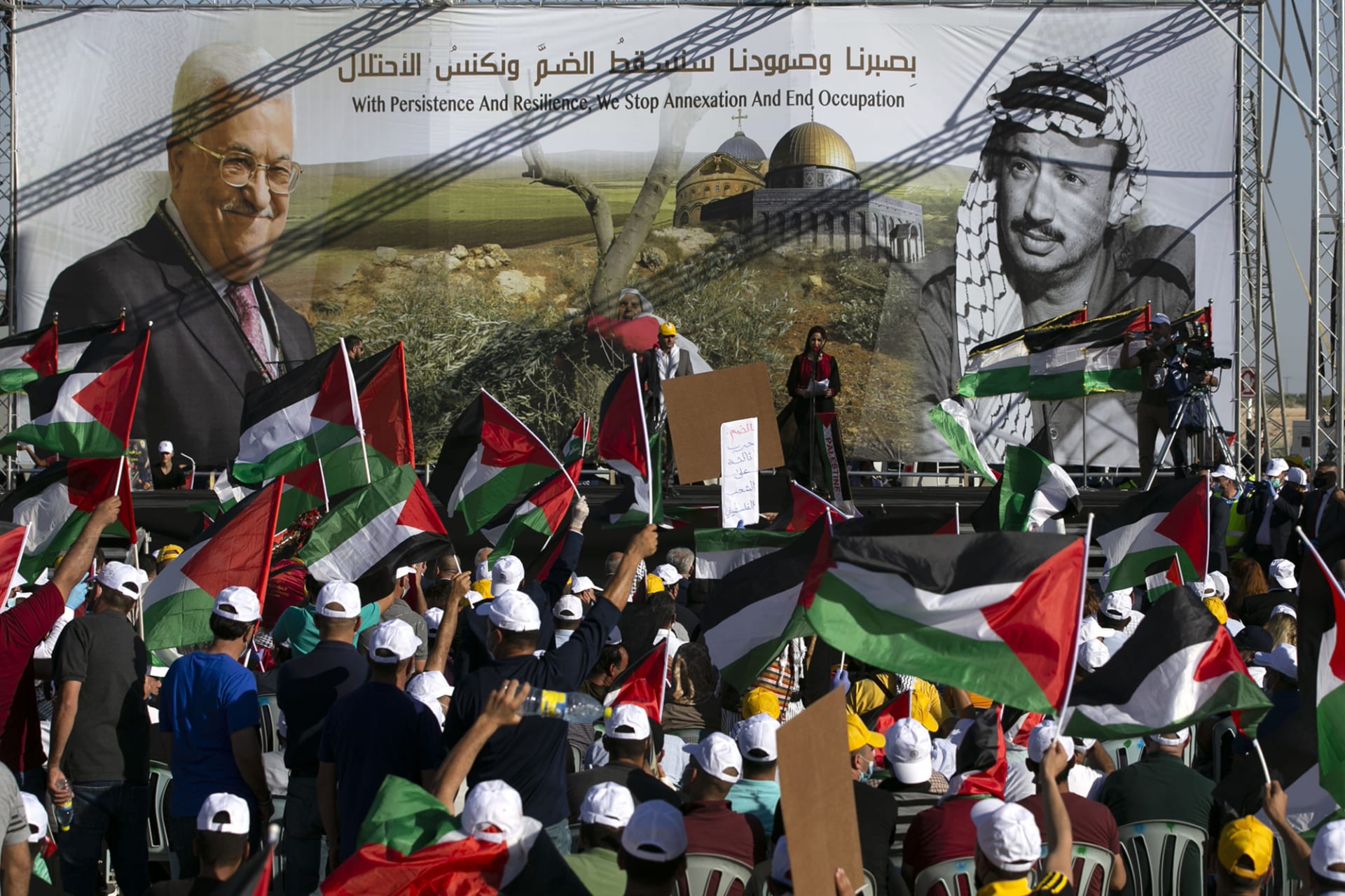 <p>Palestinians rally beneath images of President Mahmoud Abbas and his predecessor, Yasser Arafat.</p>
