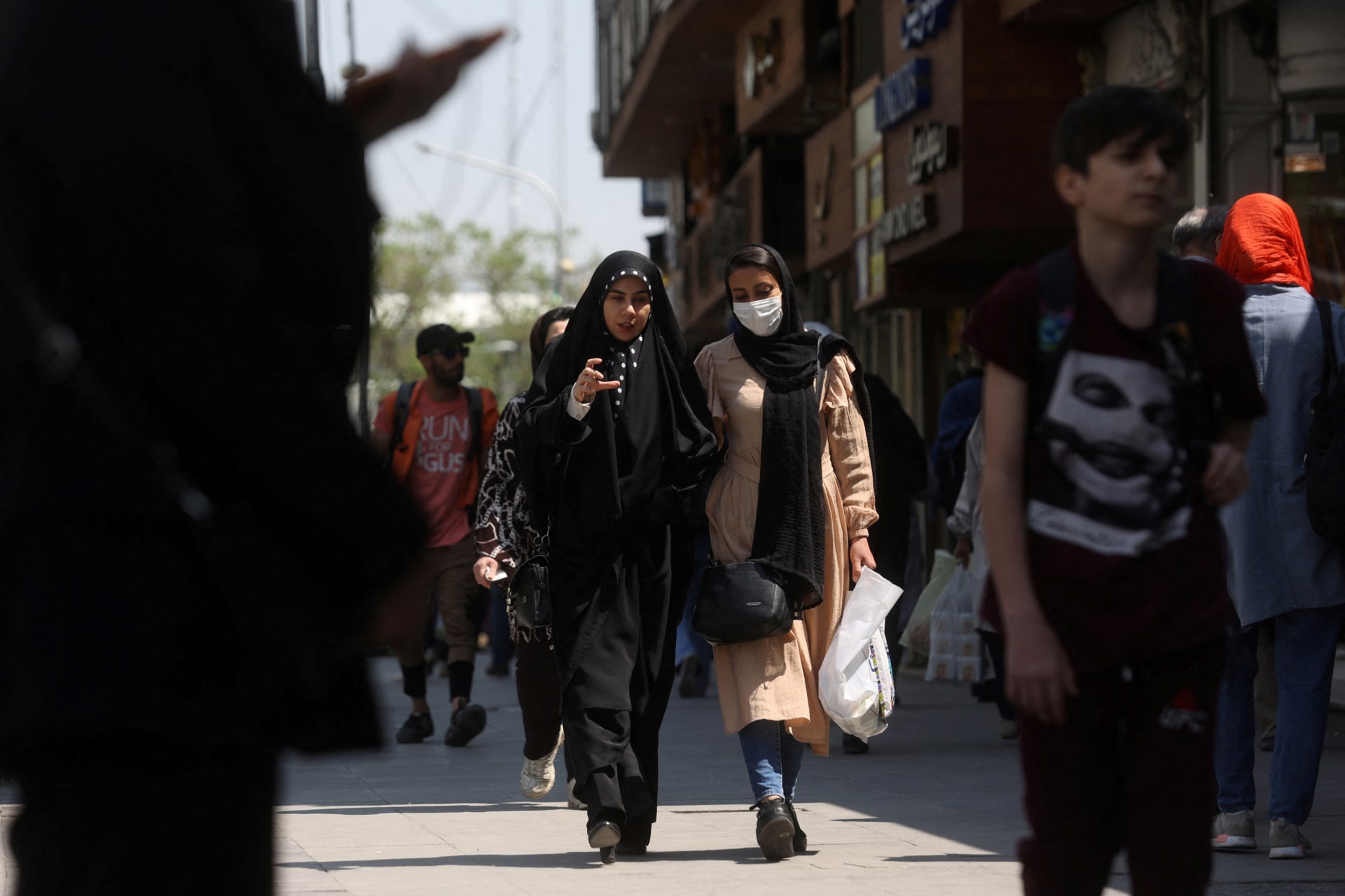 <p>Iranian women walk on a street amid the implementation of the new hijab surveillance in Tehran, Iran, April 15, 2023.</p>
