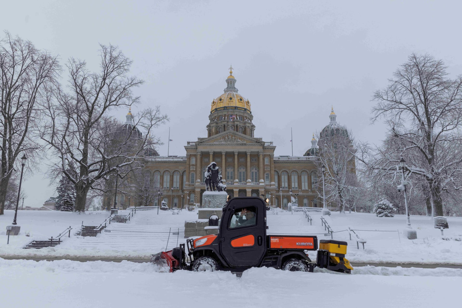 <p>Workers remove snow in front of the State Capitol Building in Des Moines, Iowa, on January 9, 2024.</p>
