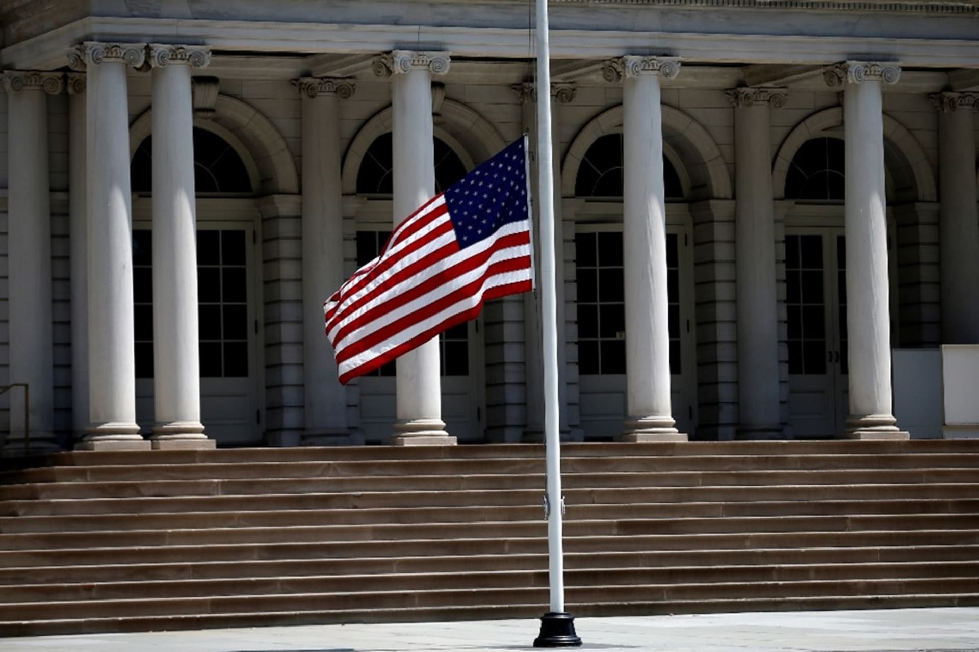 <p>The American flag flies at half-mast outside New York City Hall in Manhattan. </p>
