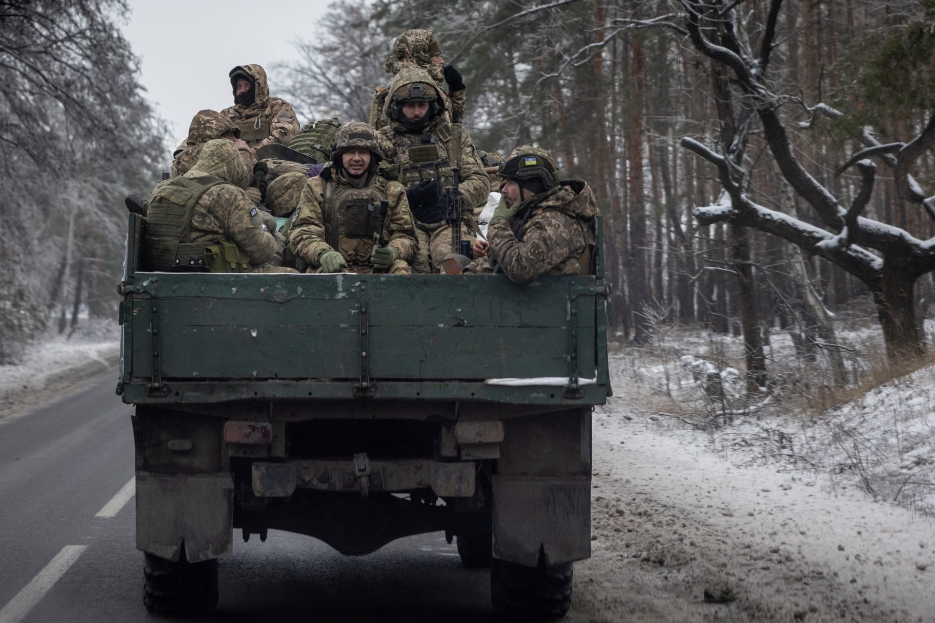 <p>Ukrainian soldiers on a truck bed in the Donetsk region in Ukraine on December 17, 2023.</p>
