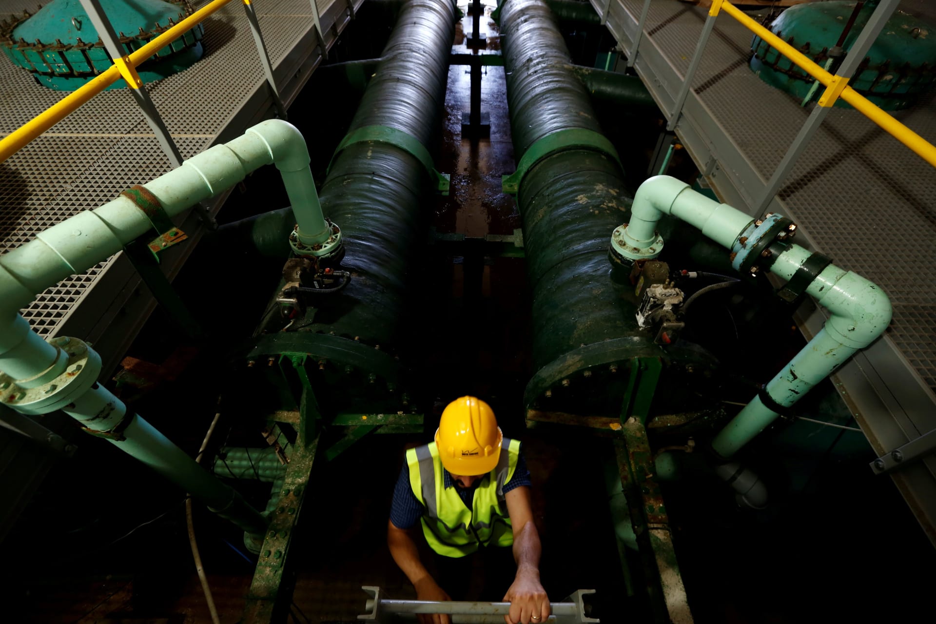 <p>An engineer climbs up from the cartridge filter hold where suspended material is filtered out of water before purification at the Pembroke reverse osmosis plant in Pembroke, Malta on May 28, 2018.</p>
