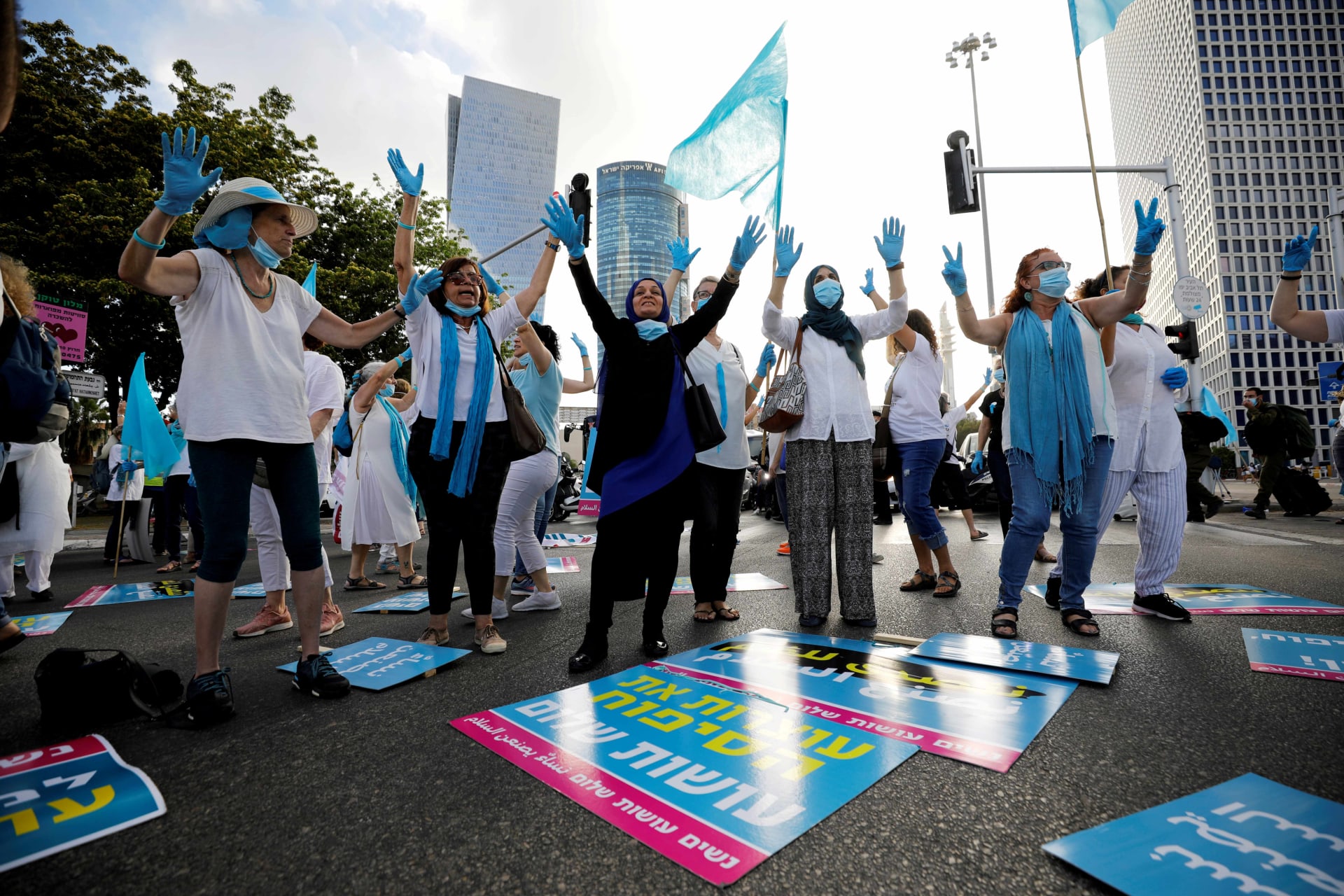 <p>Women gesture as they take part in a protest, organised by “Women Wage Peace” grassroots movement, against Israel’s planned annexation of part of the Israeli-occupied West Bank, outside government offices in Tel Aviv, Israel June 18, 2020. The placards in</p>
