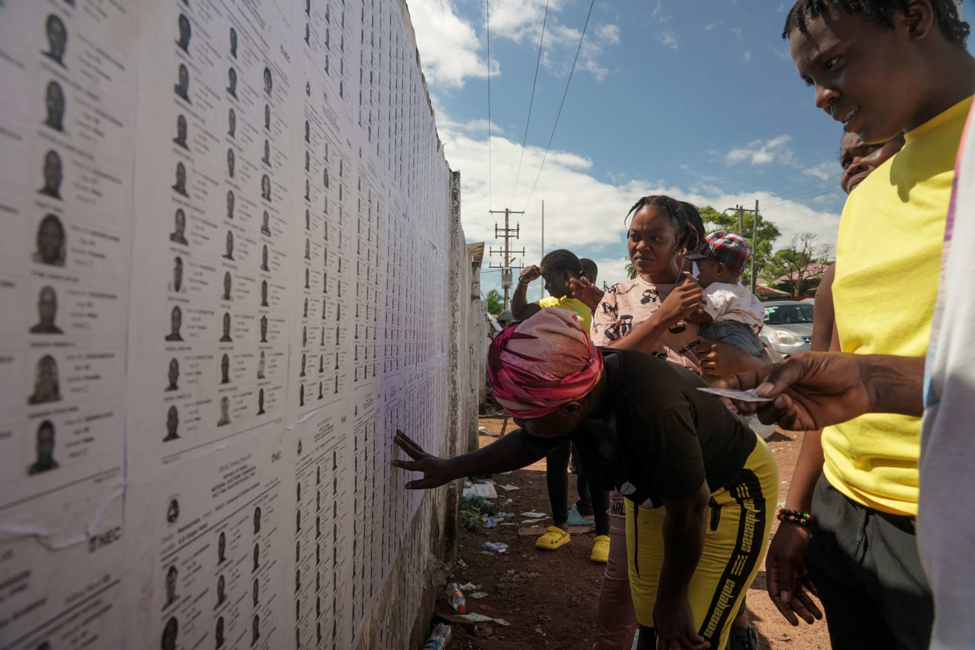 <p>Liberian voters search for their name on electoral lists before they cast their votes during Liberia’s presidential election in Monrovia, Liberia on October 10, 2023.</p>
