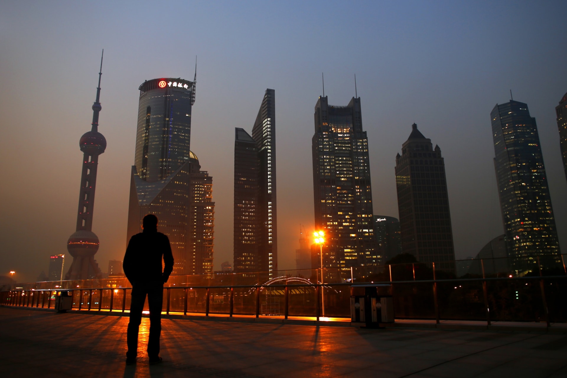 <p>A man looks at the Pudong financial district of Shanghai, China, on November 20, 2013.</p>