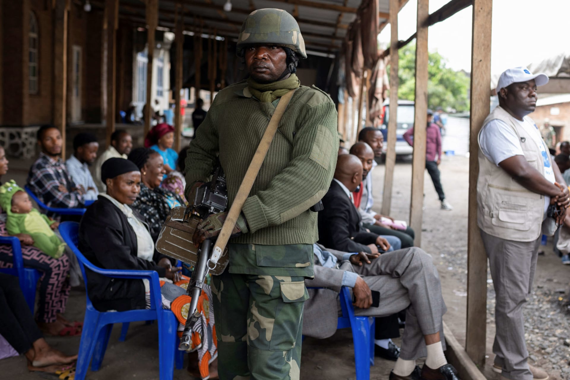<p>A Congolese soldier stands guard as civilians gather to enroll with the electoral commission as voters in Goma, North Kivu province of the Democratic Republic of Congo on February 16, 2023.</p>
