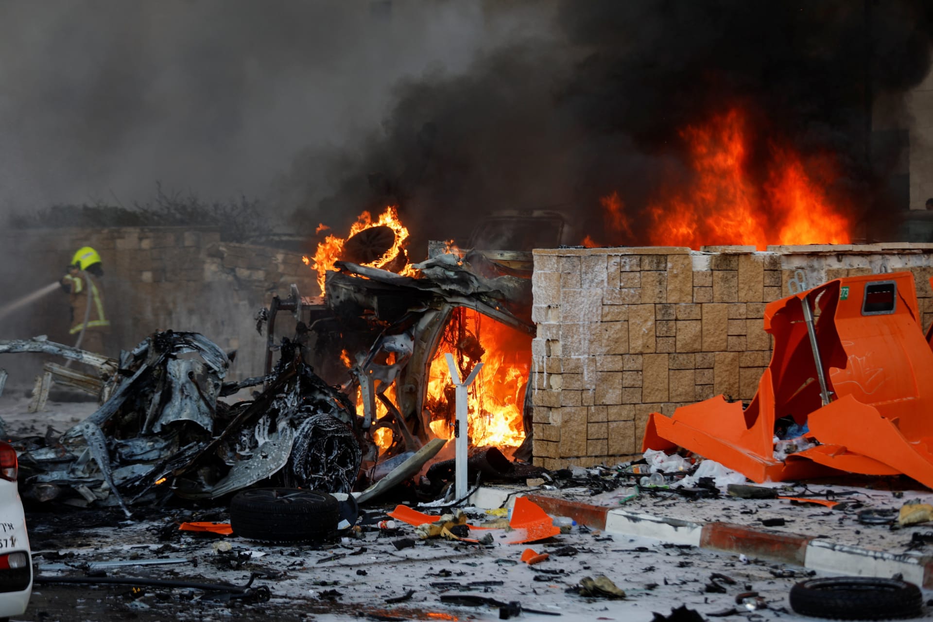 <p>Objects burn on a road after rockets were launched from the Gaza Strip, in Ashkelon, Israel.</p>
