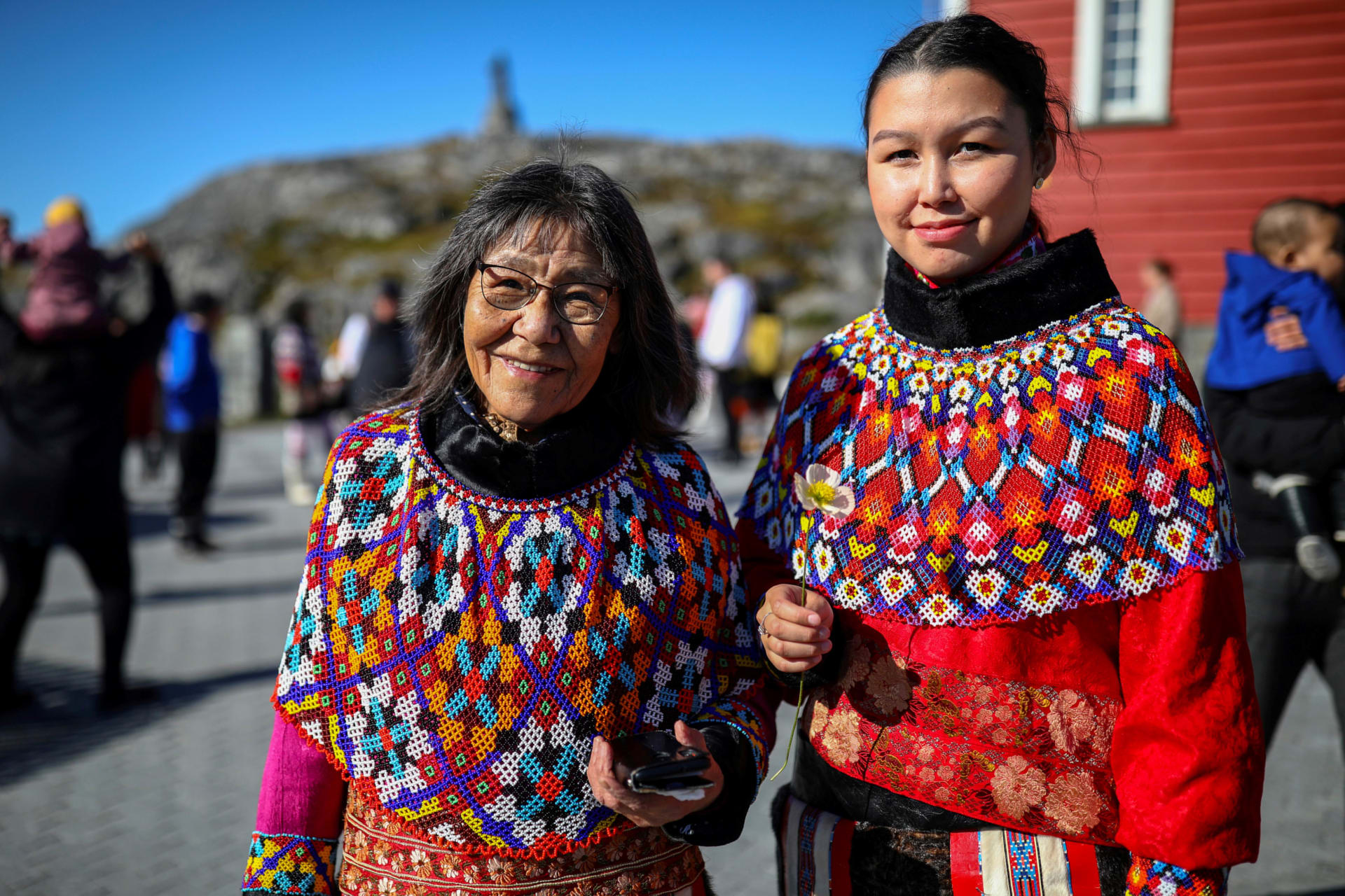 <p>A young and an old woman in traditional Inuit clothing stand after a baptism in front of the Nuuk Cathedral (Church Of Our Saviour) in Nuuk, Greenland, September 5, 2021</p>
