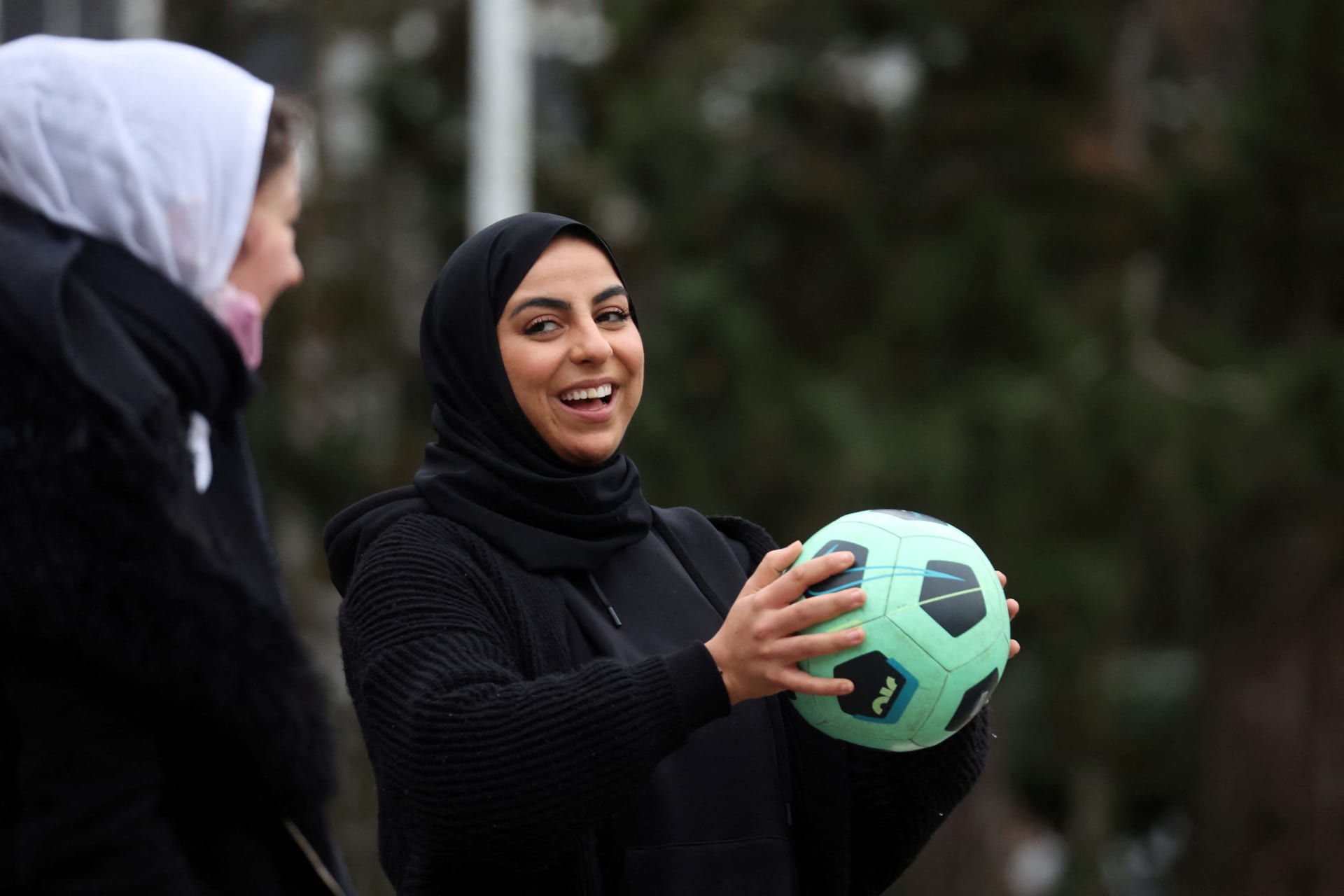 <p>Supporters of the women soccer team “Les Hijabeuses” play soccer in front of the city hall in Lille as part of a protest as French Senate examines a bill featuring controversial hijab ban in competitive sports in France, February 16, 2022.</p>
