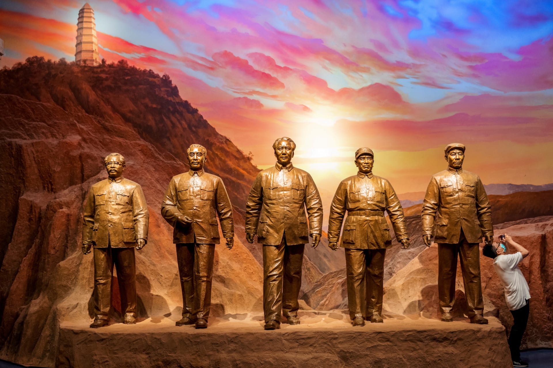 <p>A man takes pictures next to statues of former Chinese communist leaders at the Museum of the Communist Party of China in Beijing, China, on June 25, 2021.</p>