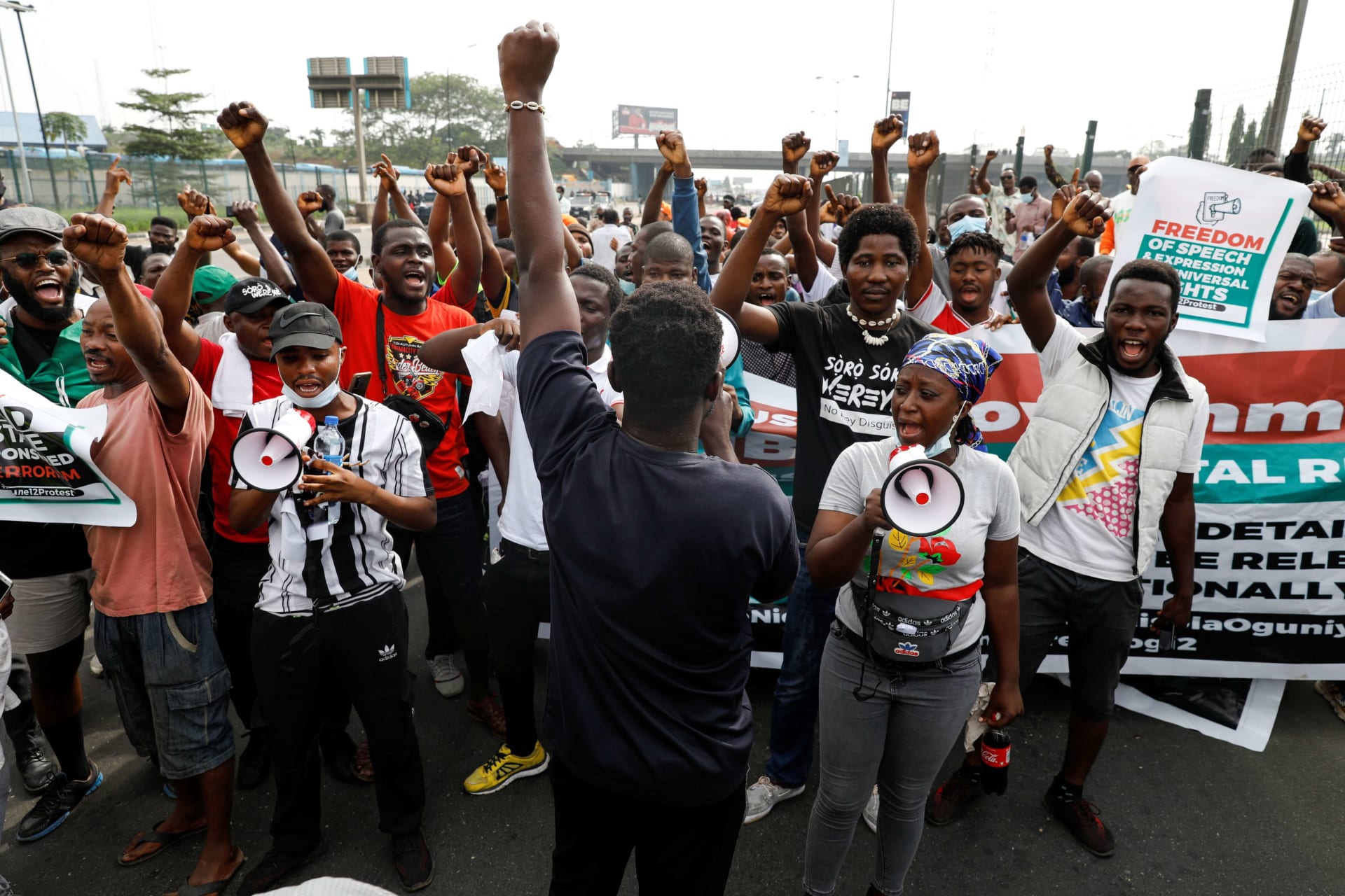 <p>Protesters raise their hands during a June 12 Democracy Day protest at the Gani Fawehinmi Park in Lagos, Nigeria on June 12, 2021.</p>
