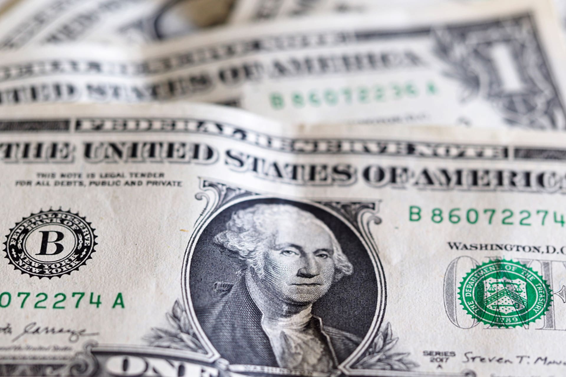 <p>In this photo illustration, one dollar bills are seen displayed</p>
