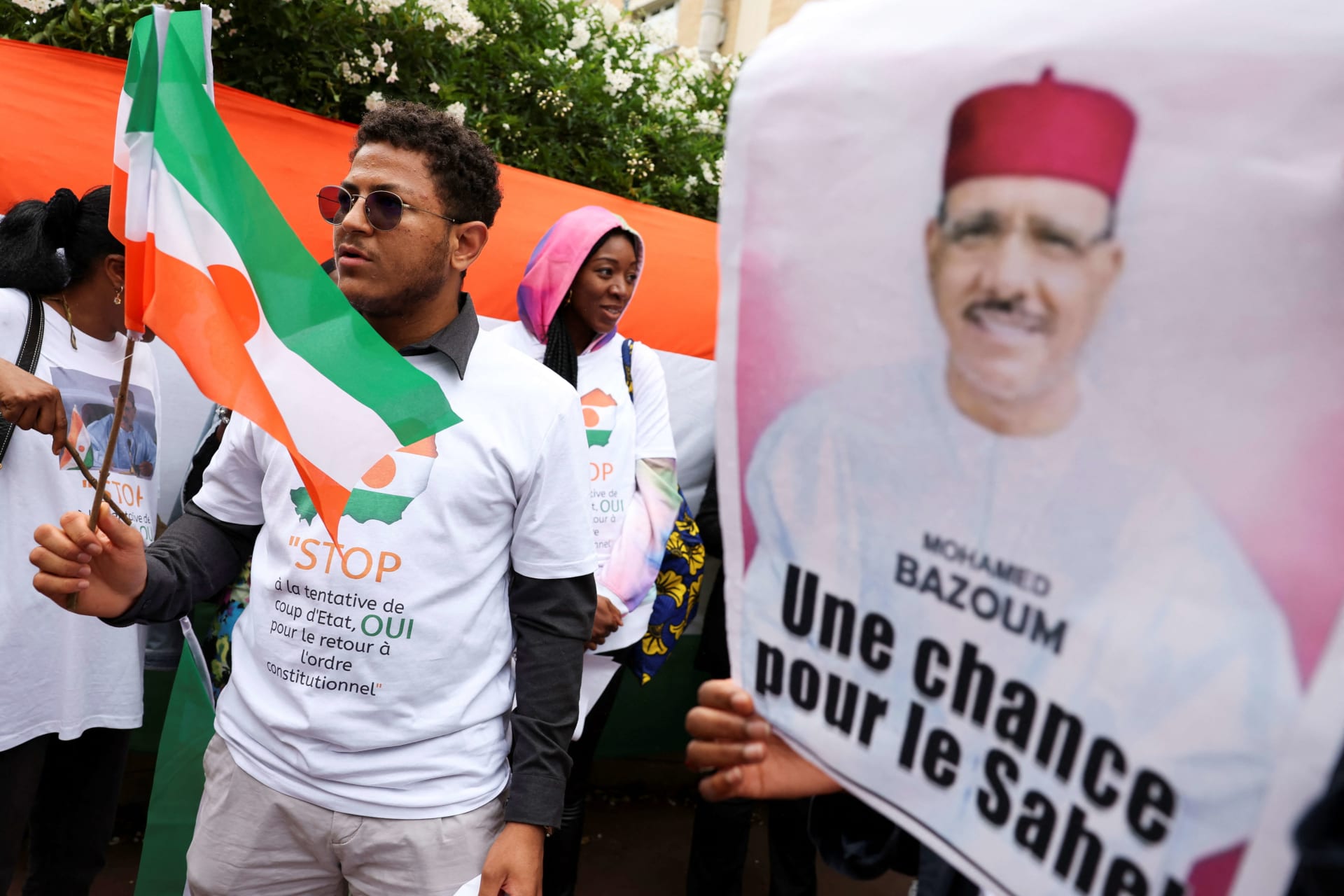 <p>A demonstrator holds Niger’s flag outside Niger’s embassy in support of the President of Niger Mohamed Bazoum in Paris, France on August 5, 2023</p>
