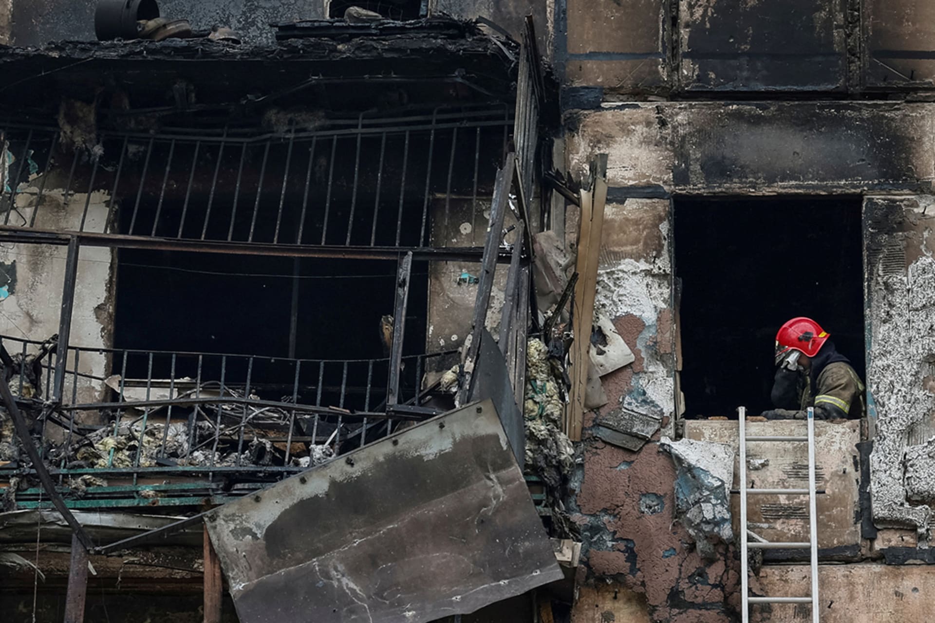 <p>A rescuer wipes their face while working in a residential building heavily damaged by a Russian missile strike, in the Dnipropetrovsk region.</p>
