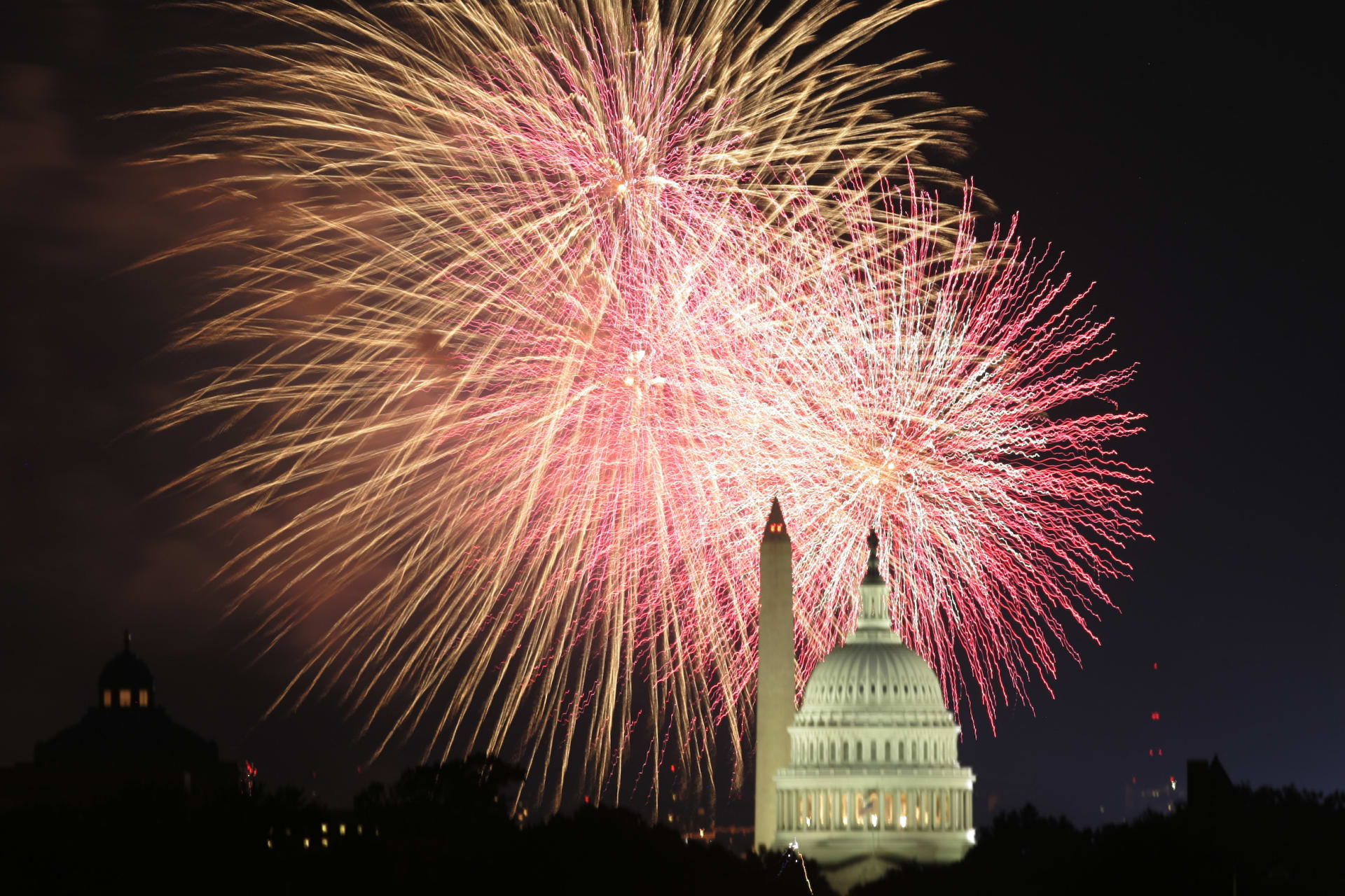 <p>Fireworks explode behind the U.S. Capitol and Washington monument on Independence Day.</p>
