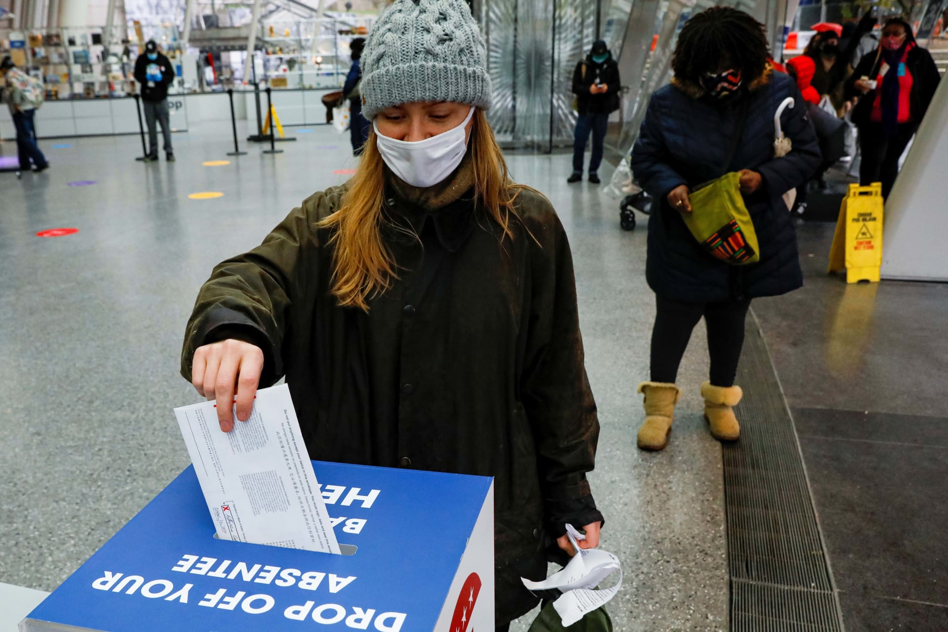 <p>A voter drops off her absentee ballot at a drop box at the Brooklyn Museum in the Brooklyn borough of New York City, New York on October 29, 2020.</p>
