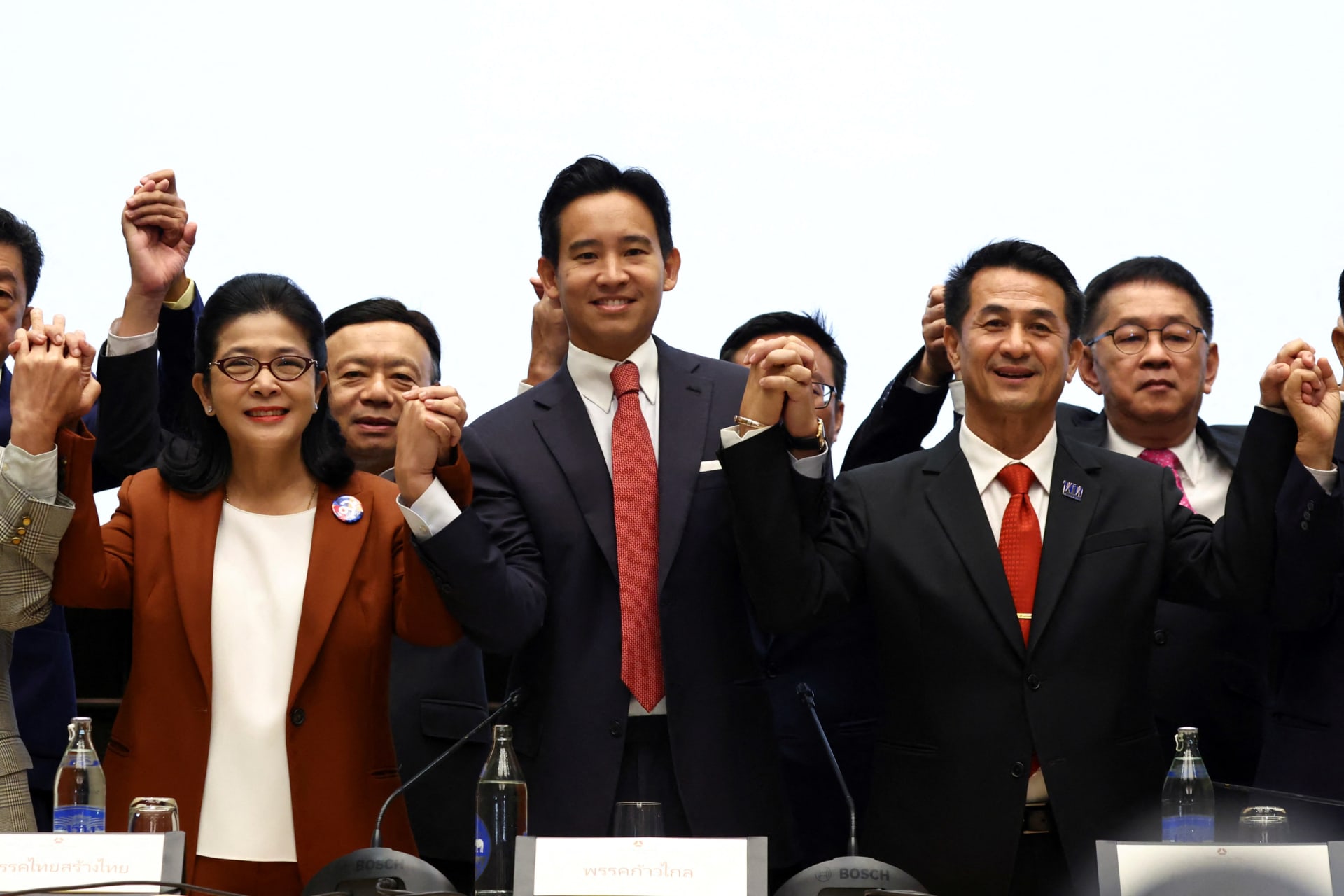 <p>Move Forward Party leader Pita Limjaroenrat holds hands with coalition party leaders following a meeting with coalition partners in Bangkok, Thailand, on May 18, 2023.</p>
