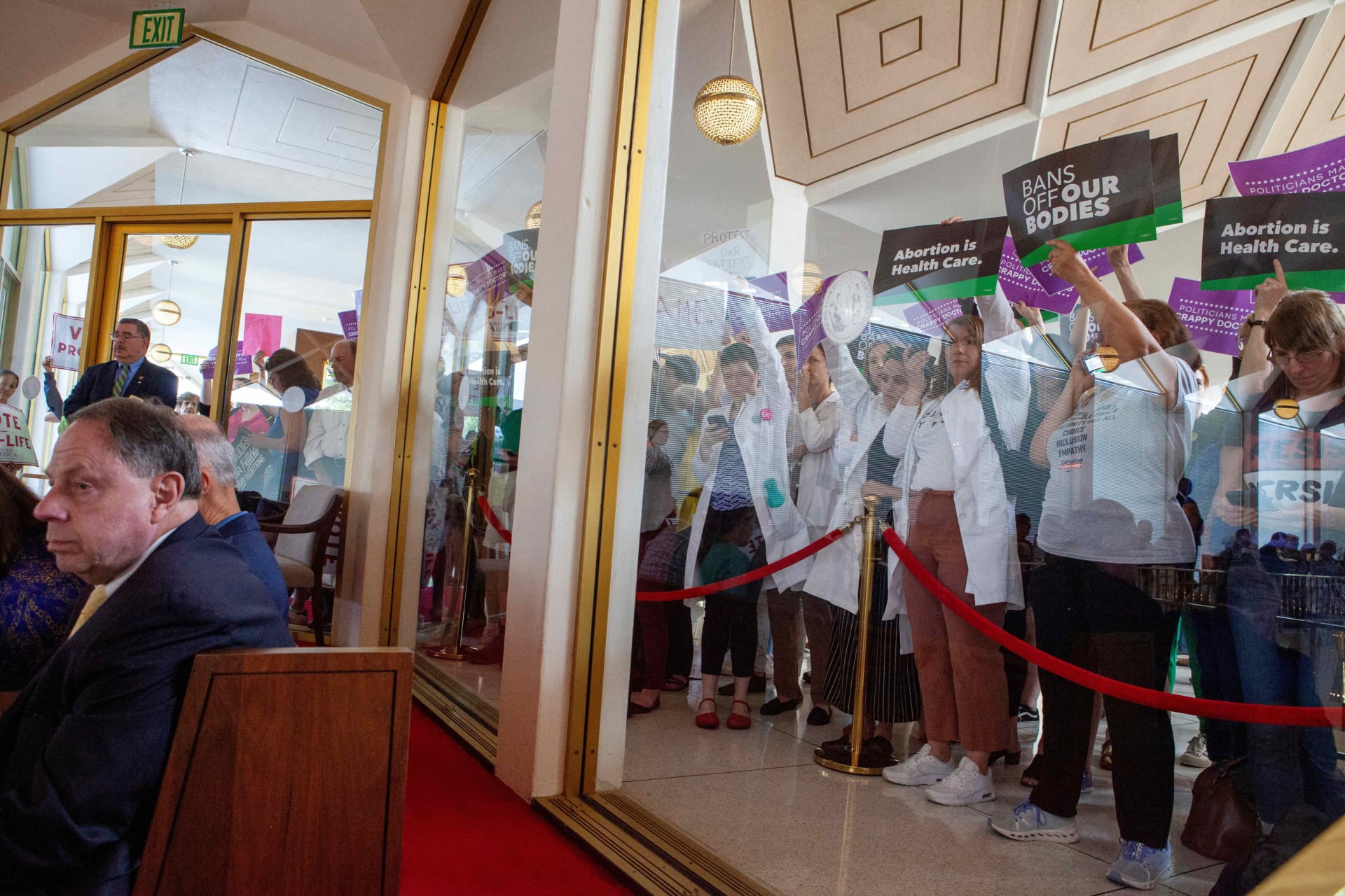 <p>North Carolina physicians hold signs to protest as North Carolina Republican lawmakers hold a vote to override Democratic Governor Roy Cooper’s veto of a bill that would ban most abortions in the state after 12 weeks, in Raleigh, North Carolina, U.S. May </p>
