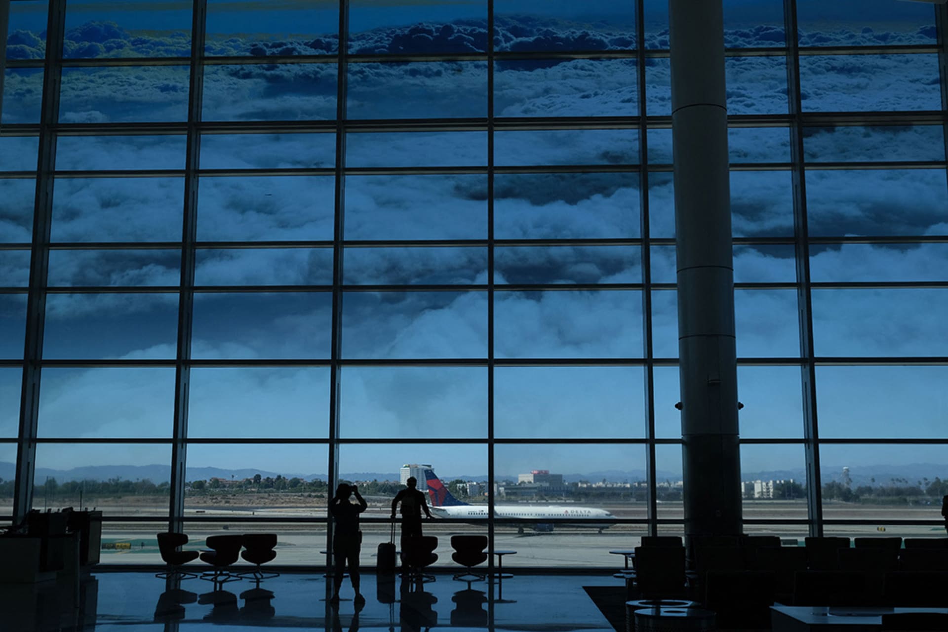 <p>Passengers gaze out the windows at Los Angeles International Airport.</p>
