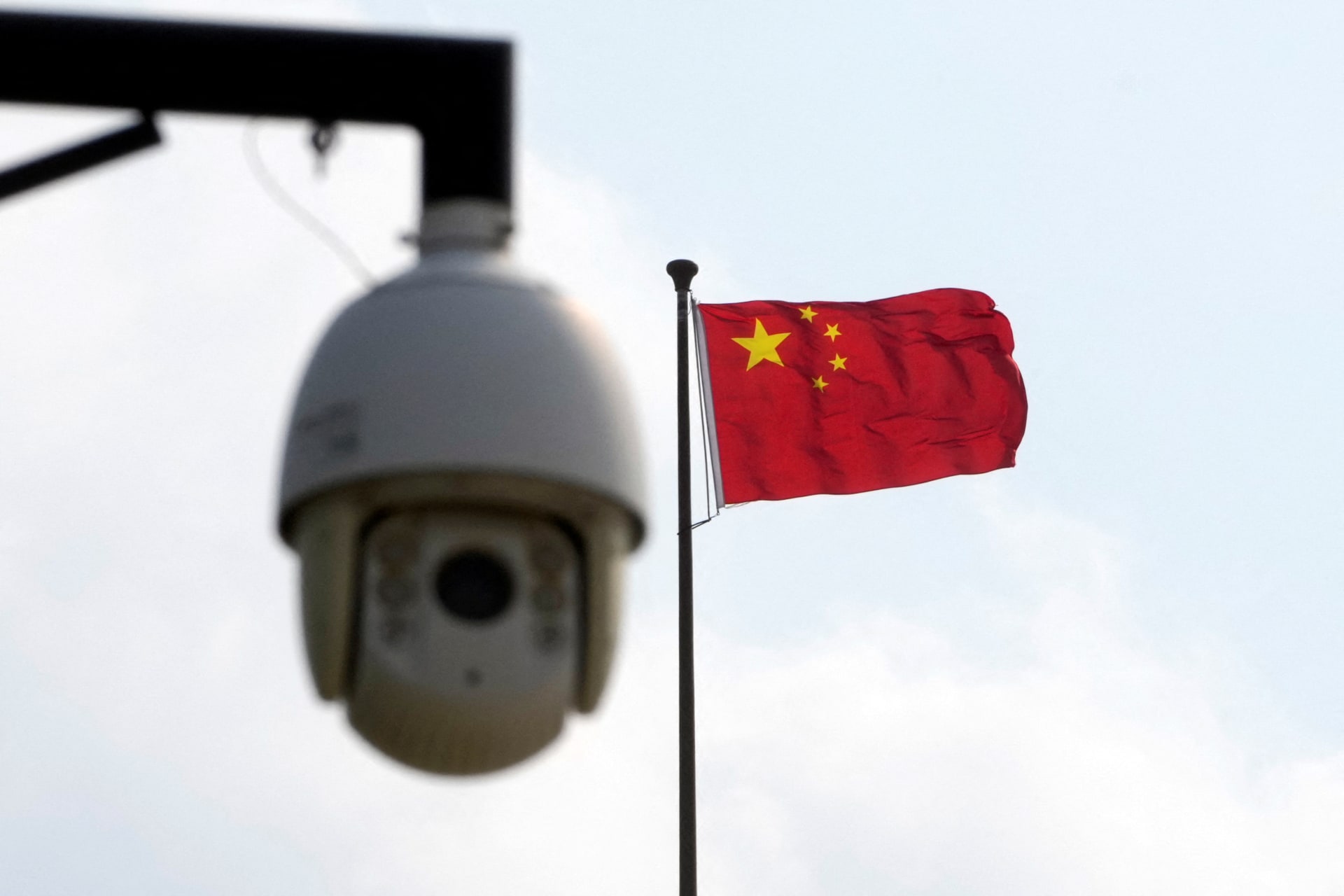 <p>A surveillance camera is seen near a Chinese flag in Shanghai, China.</p>
