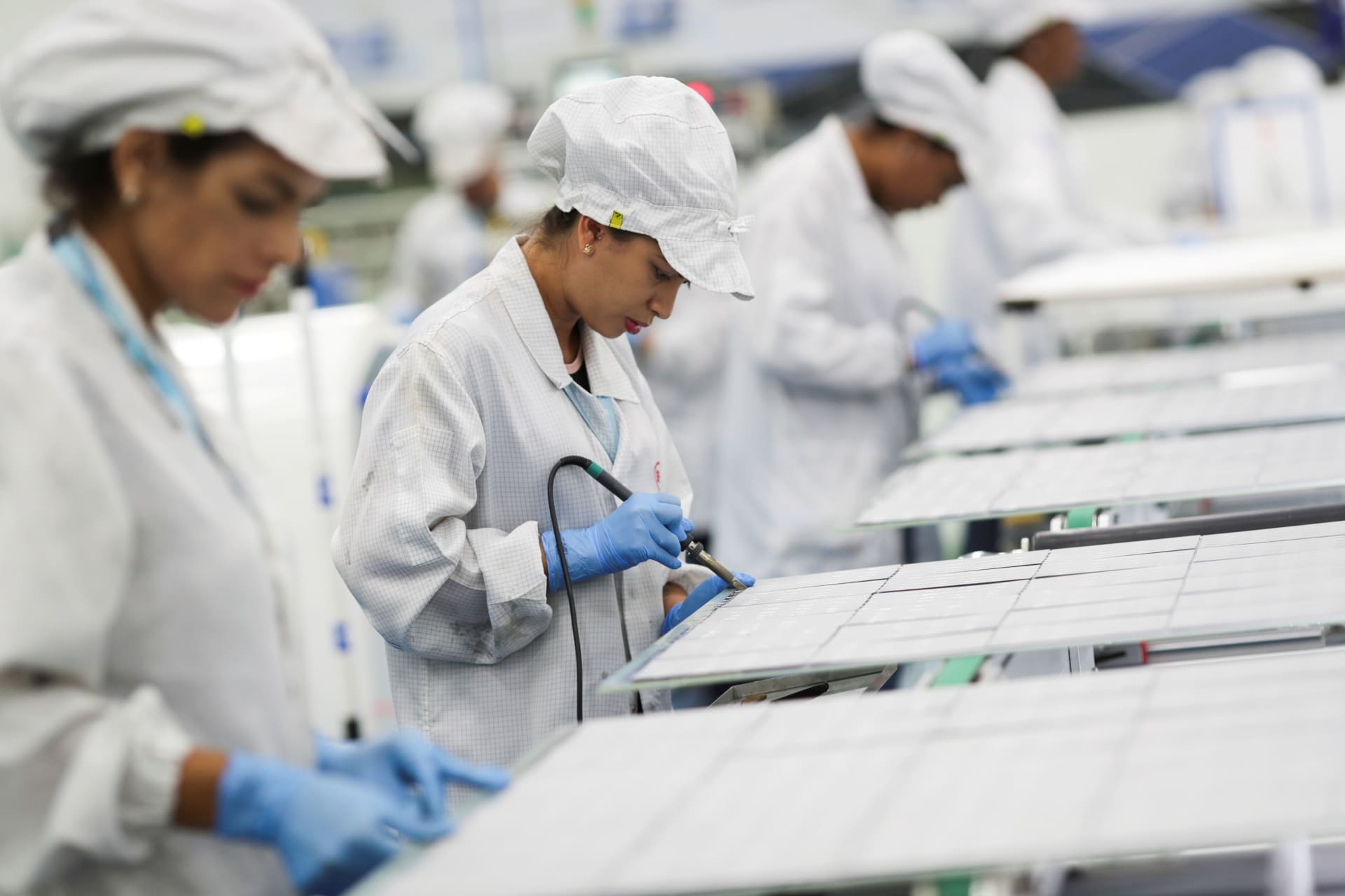 <p>Employees work on a solar energy panel of Chinese solar equipment manufacturer BYD in Campinas, Brazil, February 13, 2020.</p>
