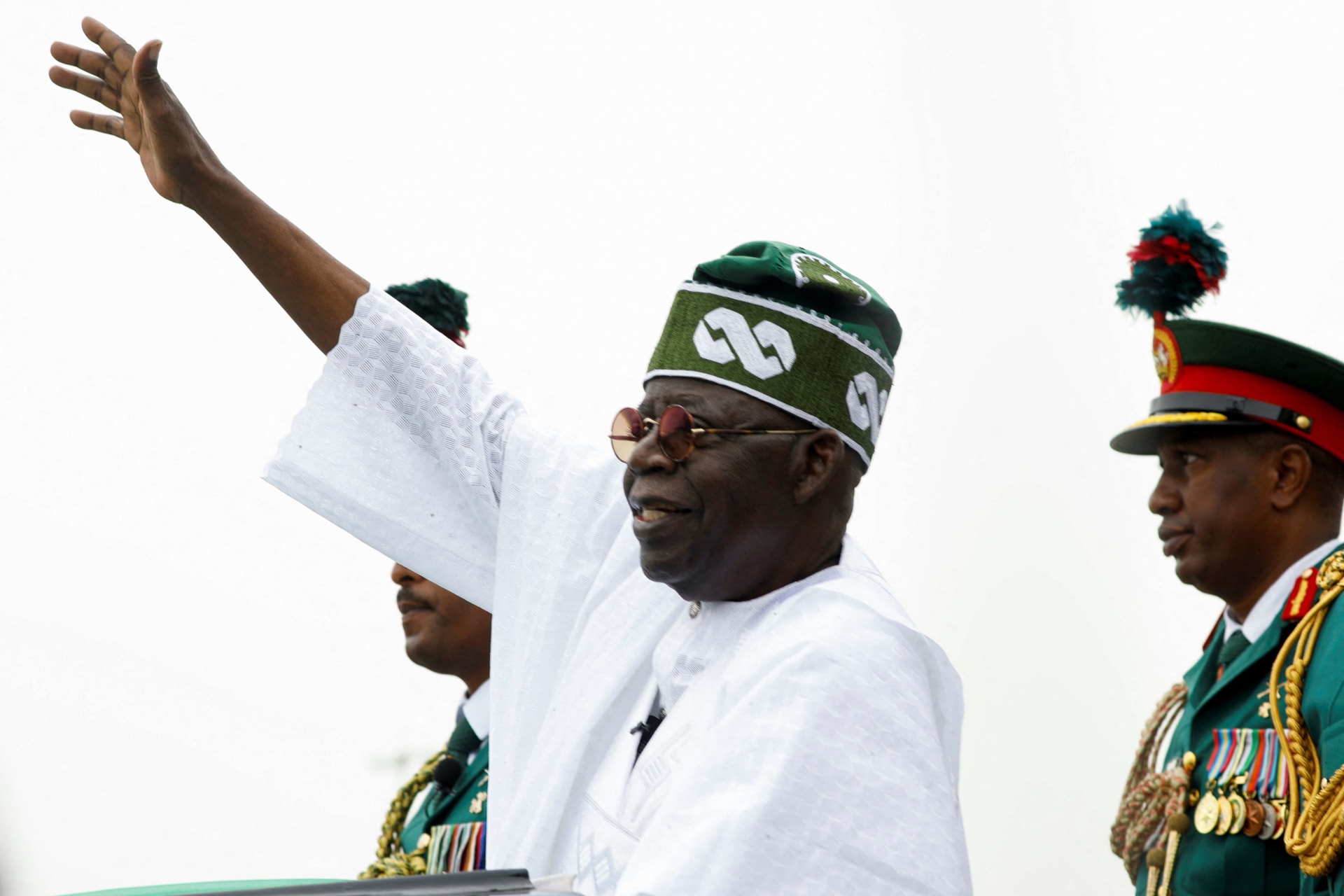 <p>Nigeria’s President Bola Tinubu waves to a crowd as he takes the traditional ride on top of a ceremonial vehicle, after his swearing-in ceremony in Abuja, Nigeria on May 29, 2023. </p>
