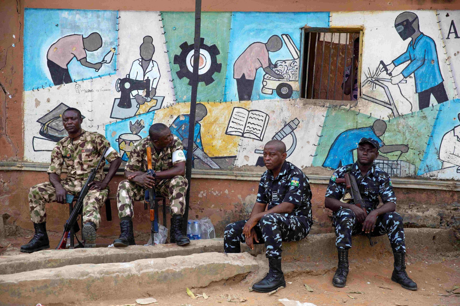 <p>A day after the elections, soldiers and police guard the entrance to a vote collation center that was stormed earlier in the day by unknown assailants on February 26, 2023. </p>
