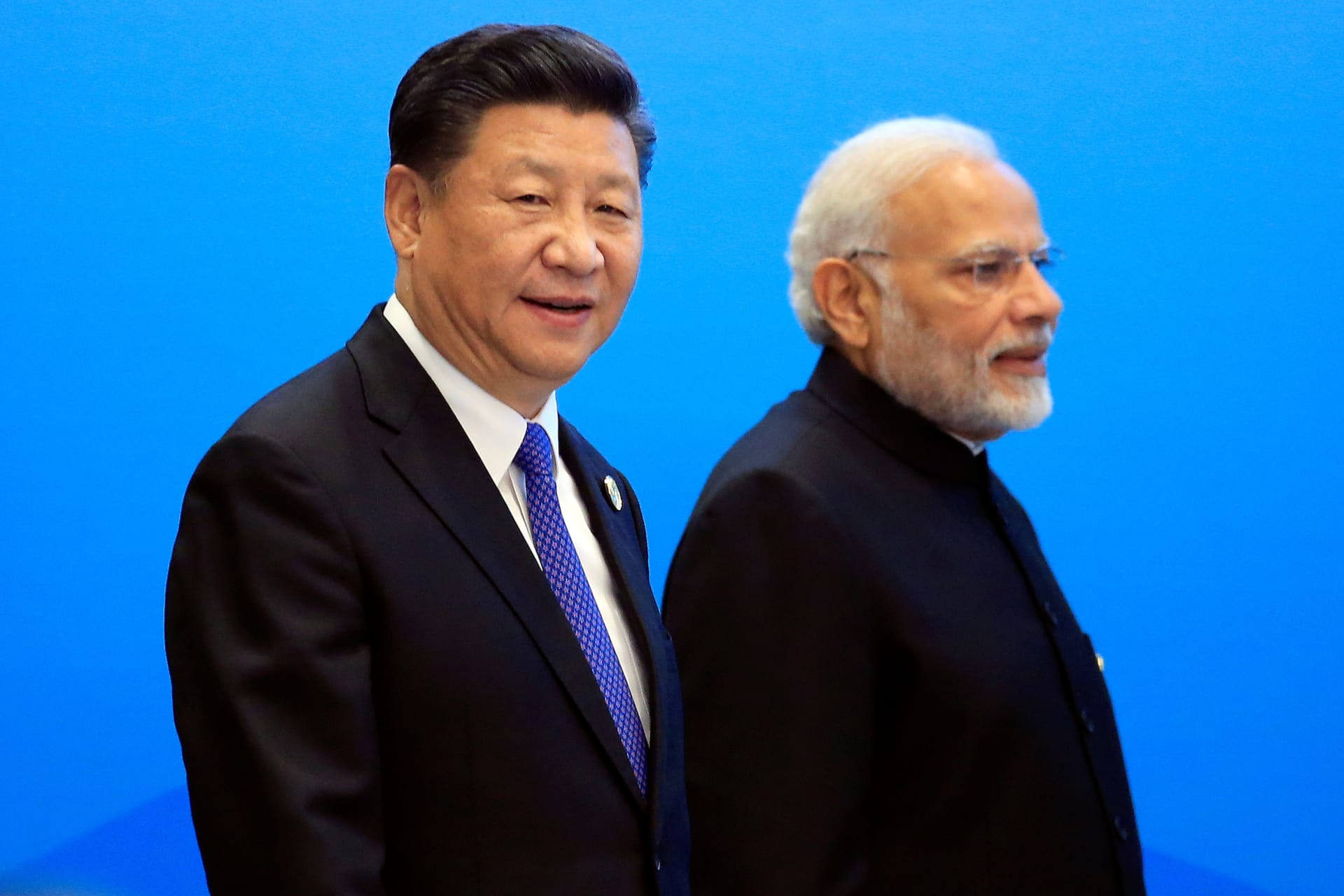 <p>China’s President Xi Jinping and India’s Prime Minister Narendra Modi arrive for a signing ceremony during the Shanghai Cooperation Organization (SCO) summit in Qingdao, China, on June 10, 2018.</p>

