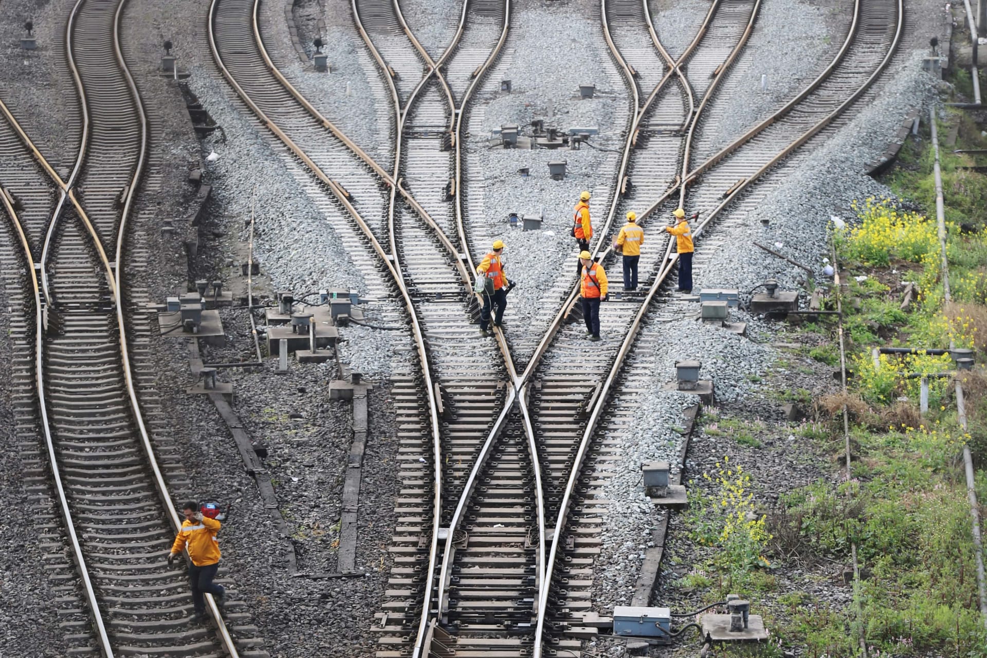 <p>Workers inspect railway tracks, which serve as a part of the Belt and Road freight rail route linking Chongqing to Duisburg, at Dazhou railway station in Sichuan province, China. China Stringer Network/Reuters</p>
