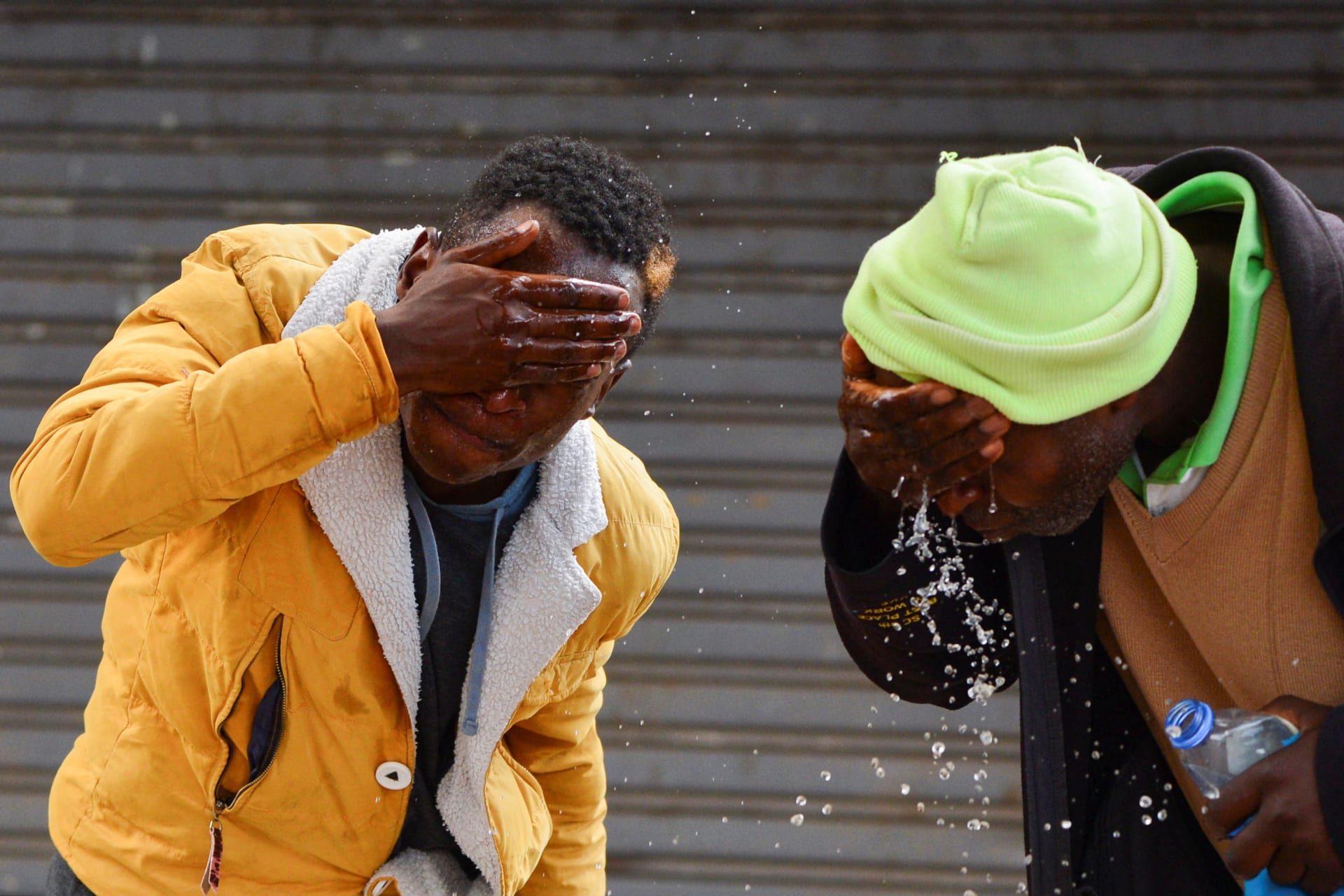 <p>Demonstrators wash their face from teargas after clashing with riot police as they participate in a nationwide protest over cost of living and President William Ruto’s government in downtown Nairobi, Kenya on March 20, 2023.</p>
