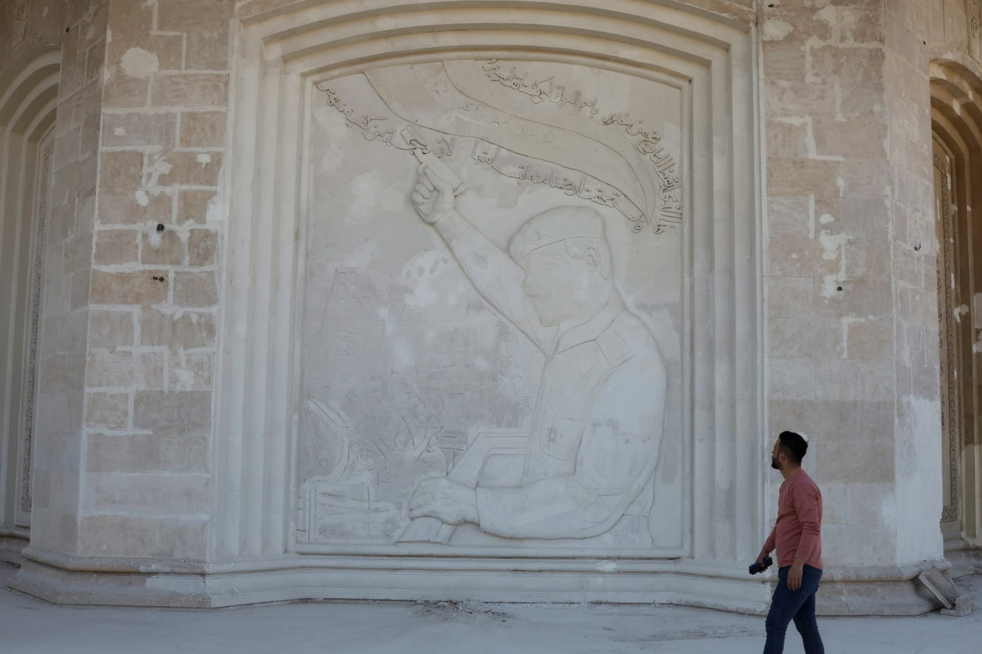 <p>A man looks at a mural of former Iraq President Saddam Hussein inside his damaged former palace in Mosul, Iraq, February 19, 2023. </p>
