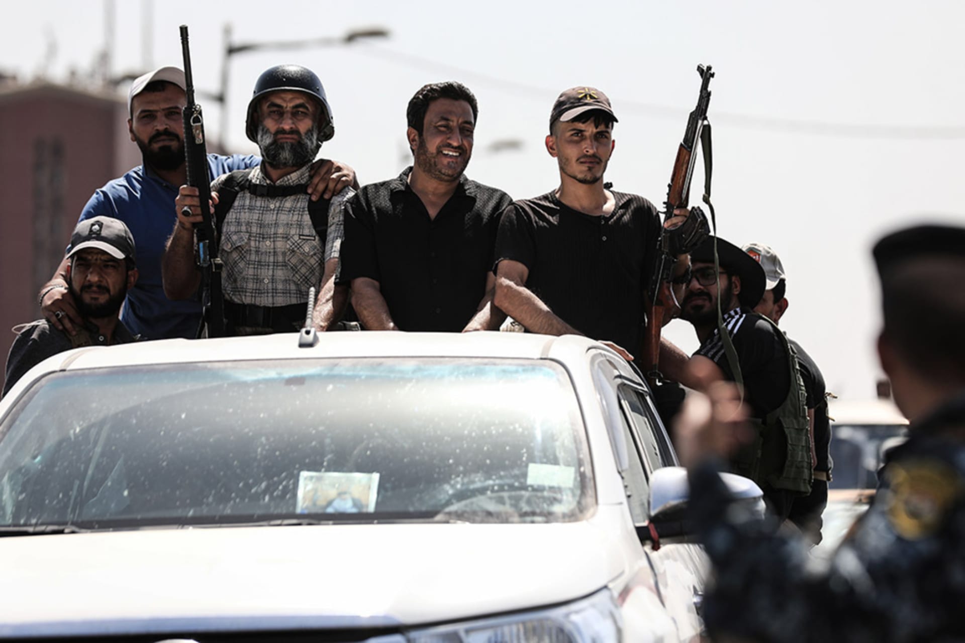 <p>Fighters from the Iran-linked militia Saraya al-Salam withdraw from a protest near Iraq’s parliament building.</p>
