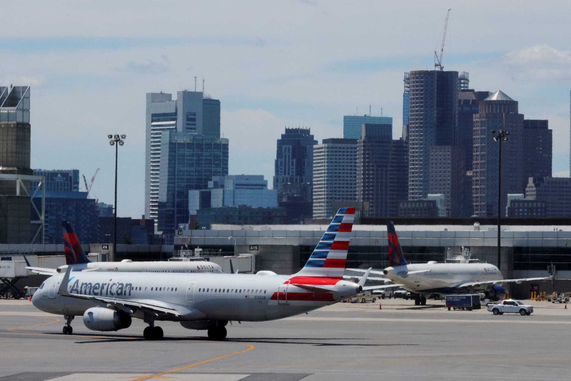<p>An American Airlines plane taxis in front of the skyline at Logan Airport before the July 4th holiday weekend in Boston, Massachusetts.</p>
