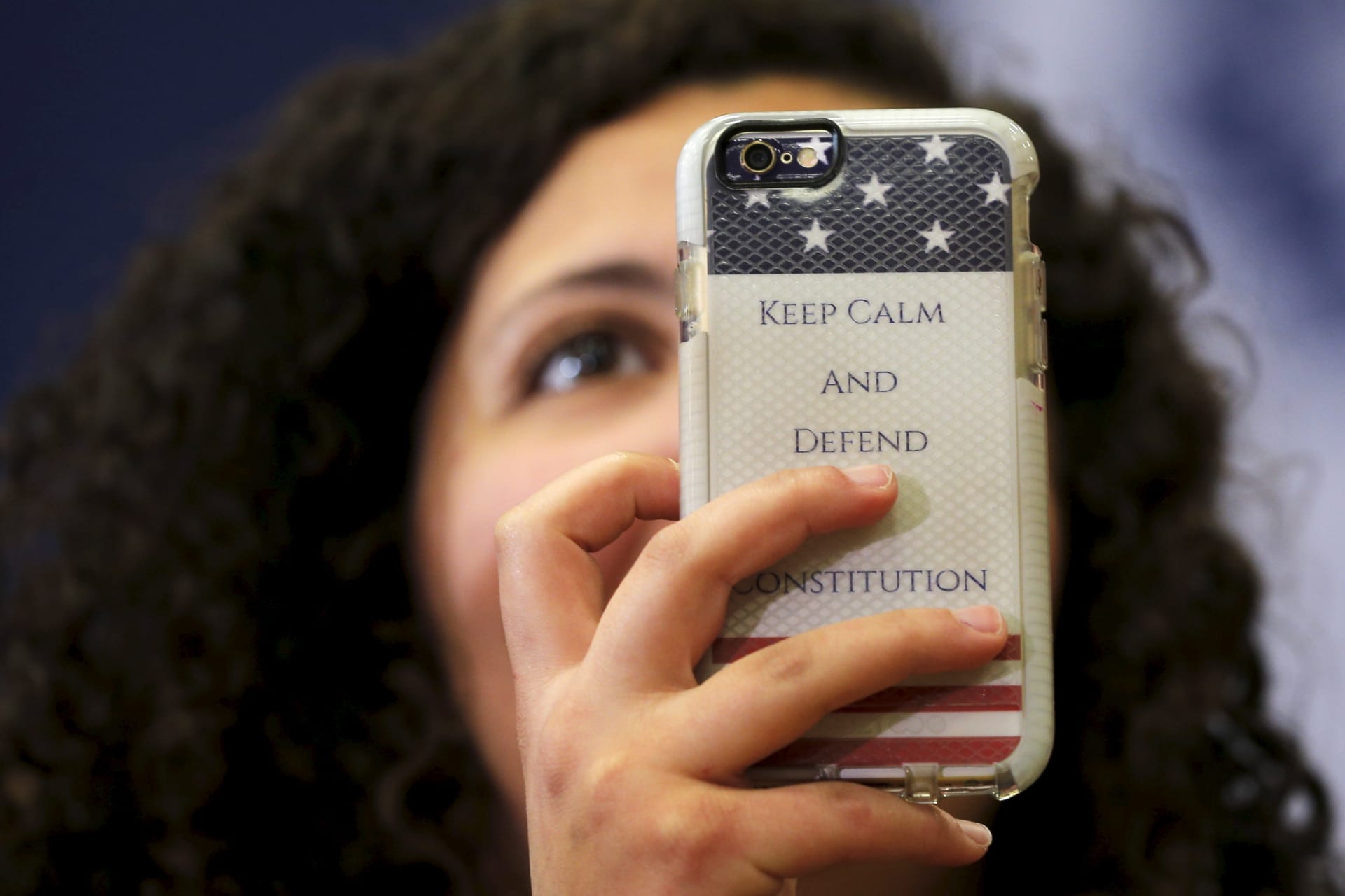 <p>An audience member holds up a phone with a case reading “Keep Calm and Defend the Constitution” during a “Get Out to Caucus” rally with U.S. Democratic presidential candidate Hillary Clinton in Cedar Rapids</p>
