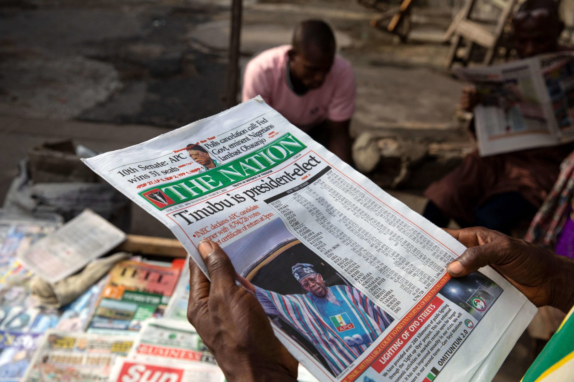 <p>A man reads a newspaper after Bola Ahmed Tinubu was declared the winner and president-elect of Nigeria after elections disputed by opposition parties in Lagos, Nigeria on March 1, 2023.</p>
