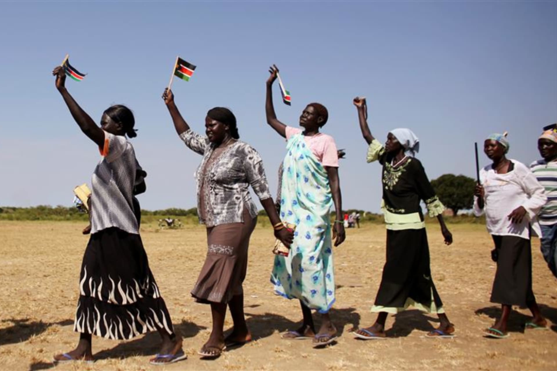 <p>Women wave South Sudan’s flags during a rally in the town of Abyei ahead of the referendum.</p>
